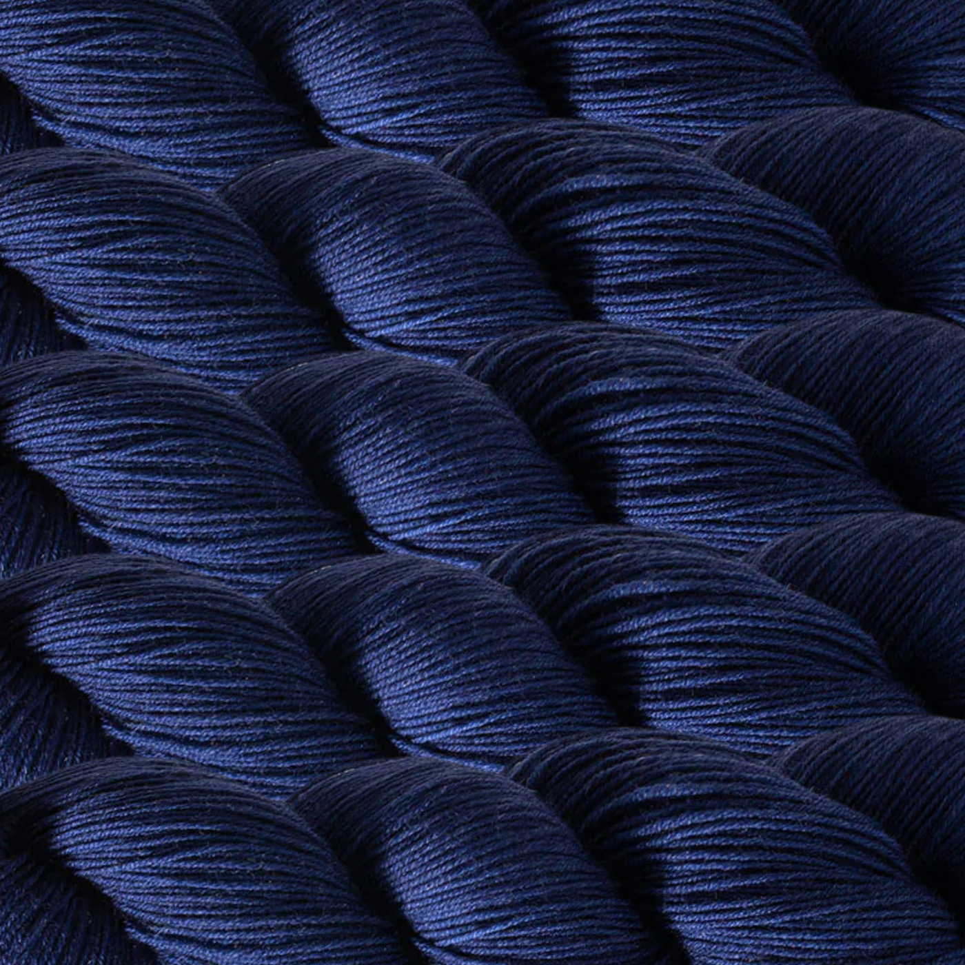 Heritage Yarn in Oxford Blue (1041), a deep, sophisticated navy hue, perfect for timeless and elegant projects. Made with Superwash Merino and Nylon, this fingering-weight yarn ensures durability and versatility. Offered in 1 lb. cones with 1,996 yards, it's ideal for weaving, knitting, and crocheting.