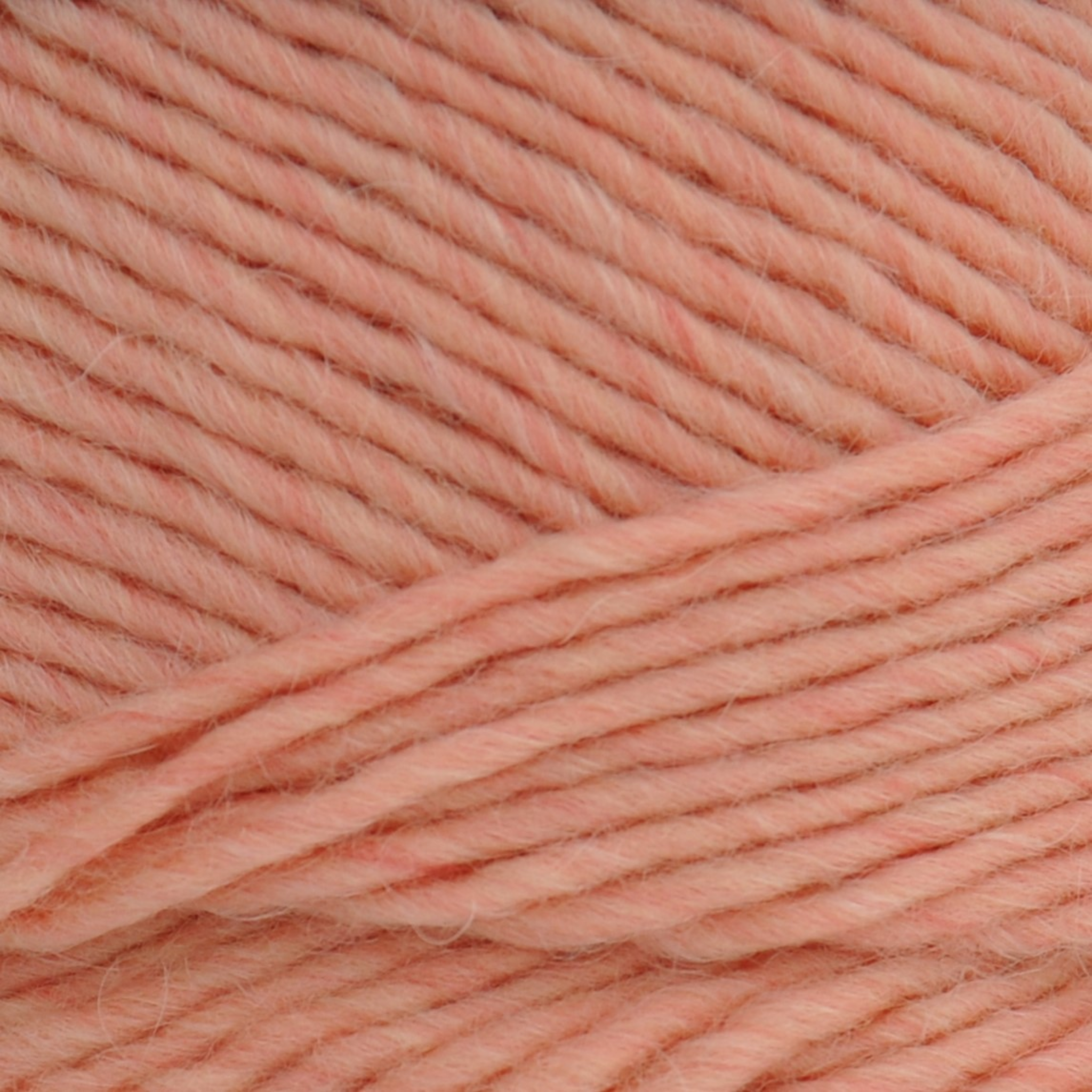 Brown Sheep Lamb’s Pride Worsted wool-mohair yarn close-up in Guava peach — available at Revolution Fibers