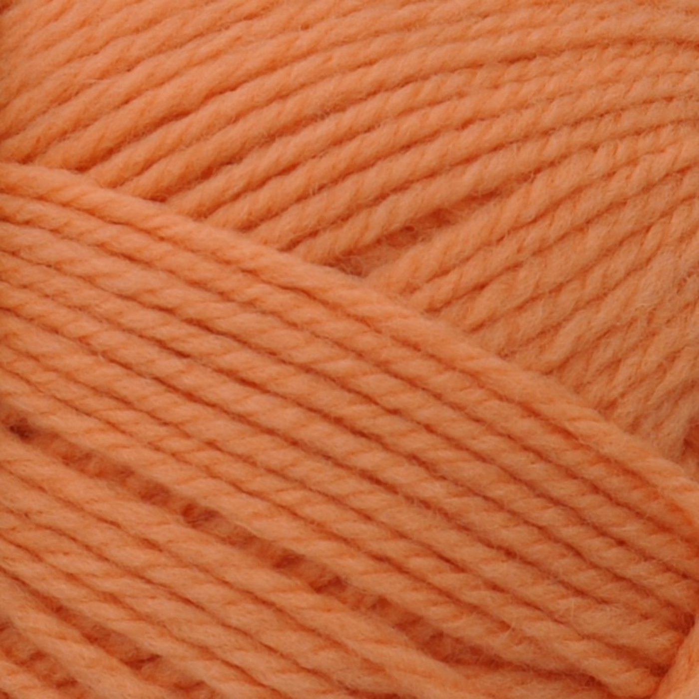 Brown Sheep Nature Spun Sport wool yarn skein, Luscious Peach soft coral hue — 184 yds at Revolution Fibers