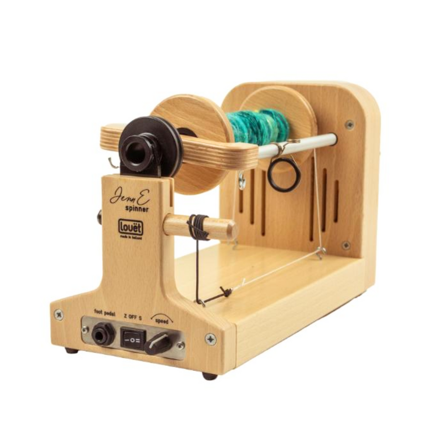 Louet Jenn E electric spinning wheel with a turquoise yarn bobbin, showcasing its compact maple frame and built-in controls.