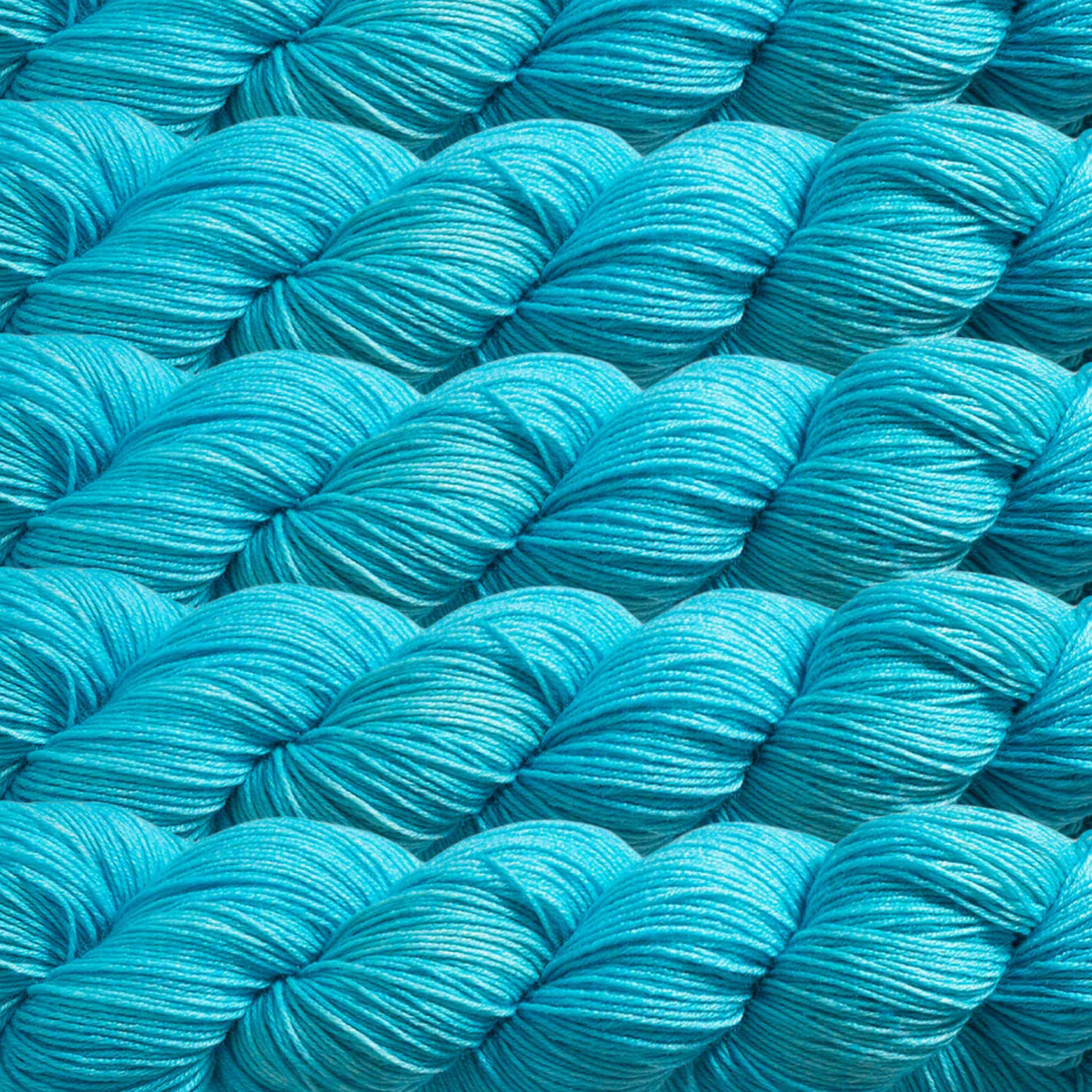 Heritage Yarn in Jamaica Bay (1016), a bright turquoise shade inspired by vibrant tropical waters. Made with a blend of Superwash Merino and Nylon, this fingering-weight yarn is perfect for weaving, knitting, and crocheting eye-catching creations. Available in 1 lb. cones with 1,996 yards for endless crafting possibilities.