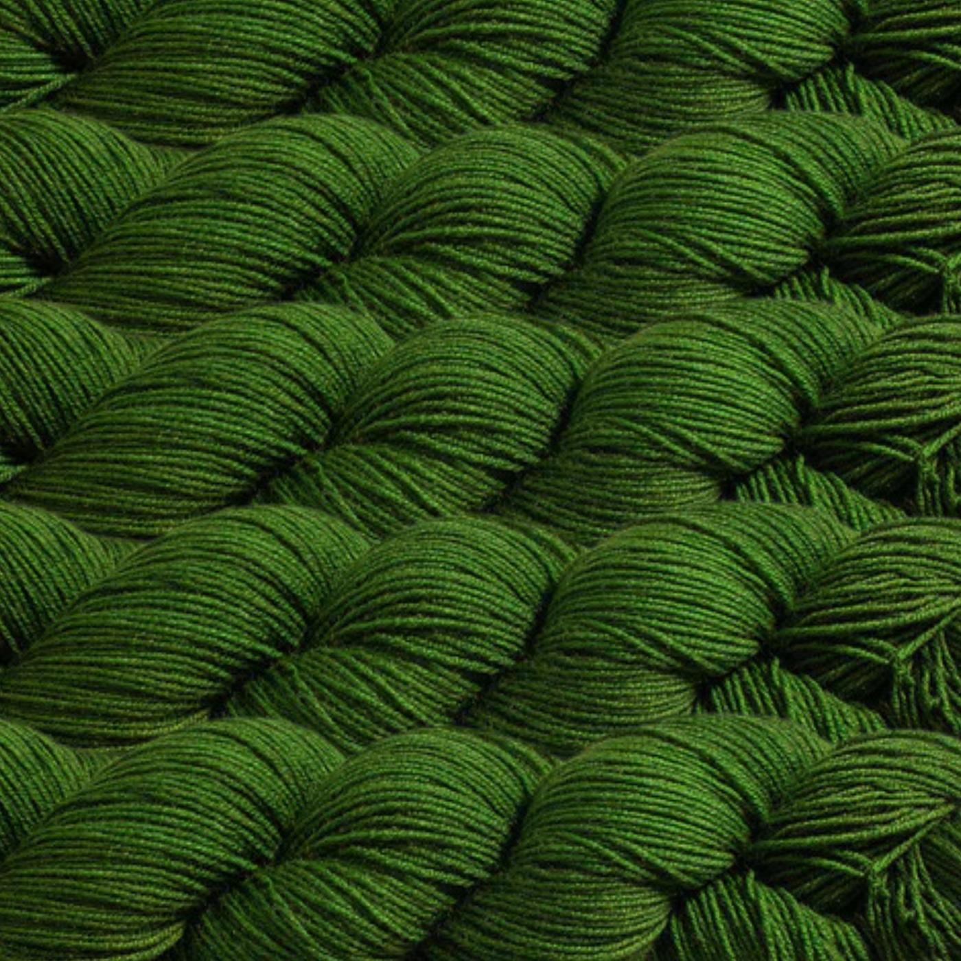 Heritage Yarn in Evergreen (1021), a deep, rich green reminiscent of lush forests and timeless foliage. This fingering-weight yarn, made with Superwash Merino and Nylon, offers durability and vibrant color. Perfect for weaving, knitting, and crocheting with 1 lb. cones providing 1,996 yards for endless creative possibilities.