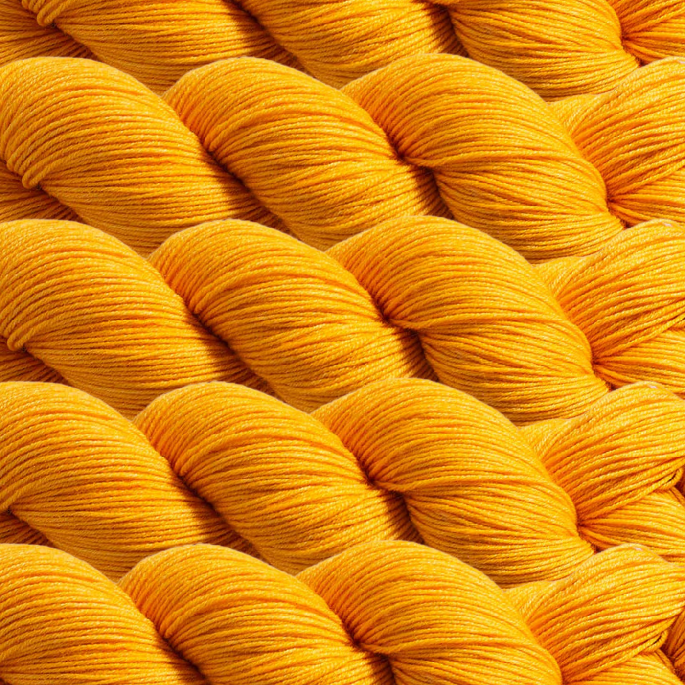 Heritage Yarn in Marigold (1022), a vibrant golden-yellow hue inspired by blooming marigolds. This fingering-weight yarn, made with Superwash Merino and Nylon, offers durability and radiant color. Ideal for weaving, knitting, and crocheting, with 1 lb. cones providing 1,996 yards for limitless creative projects.