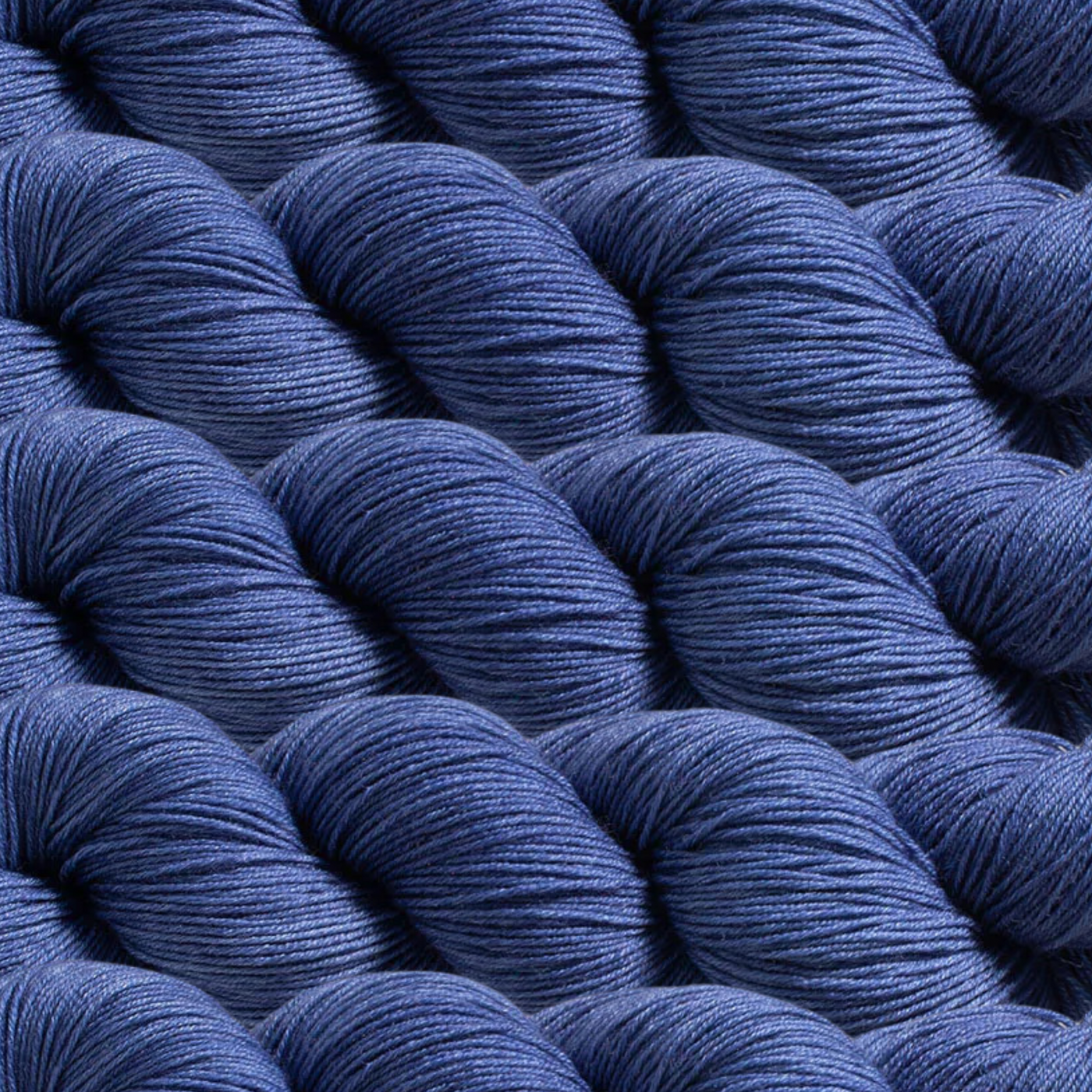 Heritage Yarn in Windmill Blue (1043), a serene and muted blue reminiscent of countryside skies. Crafted with Superwash Merino and Nylon, this fingering-weight yarn offers softness, durability, and versatility. Available in 1 lb. cones with 1,996 yards, perfect for weaving, knitting, and crocheting projects.