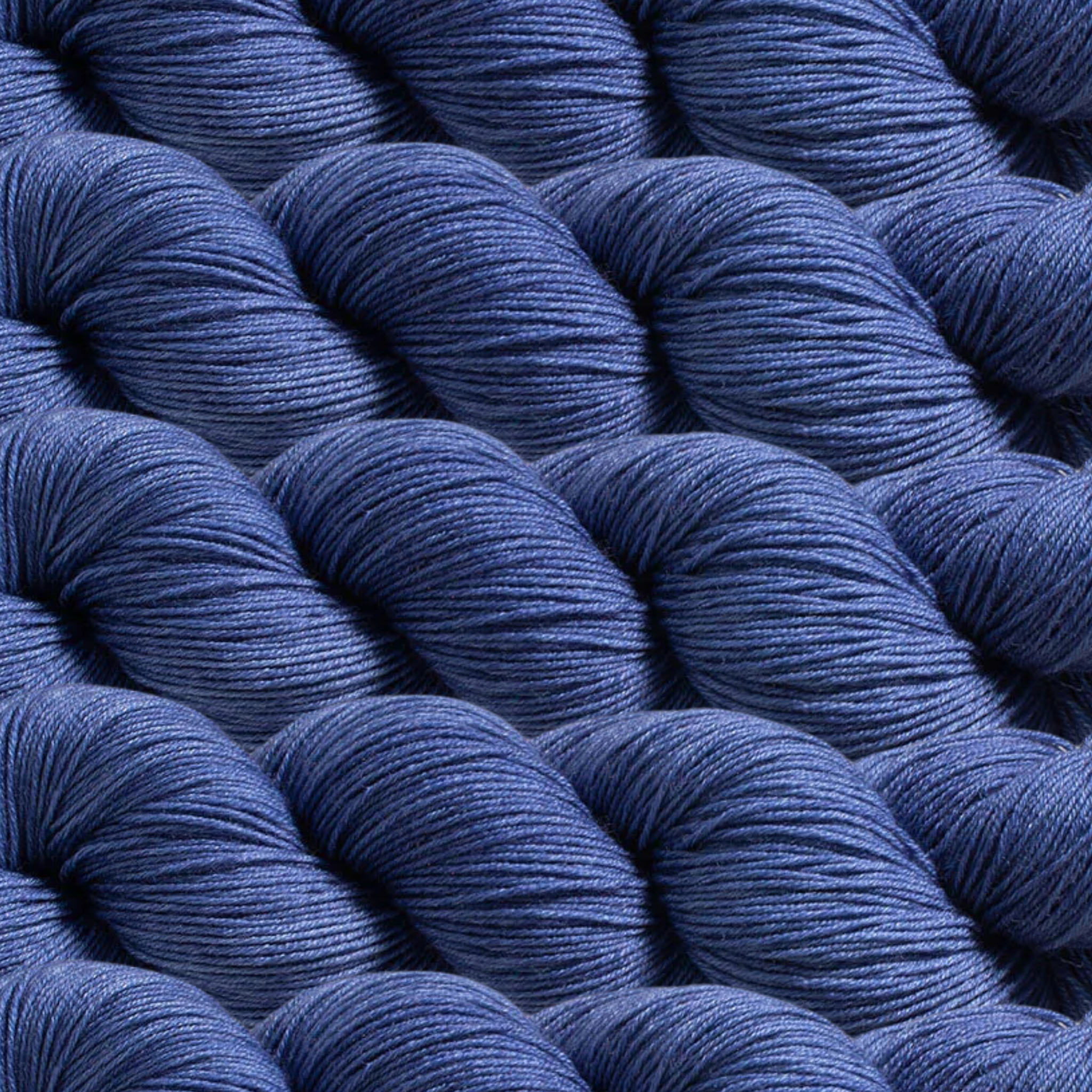 Heritage Yarn in Windmill Blue (1043), a serene and muted blue reminiscent of countryside skies. Crafted with Superwash Merino and Nylon, this fingering-weight yarn offers softness, durability, and versatility. Available in 1 lb. cones with 1,996 yards, perfect for weaving, knitting, and crocheting projects.