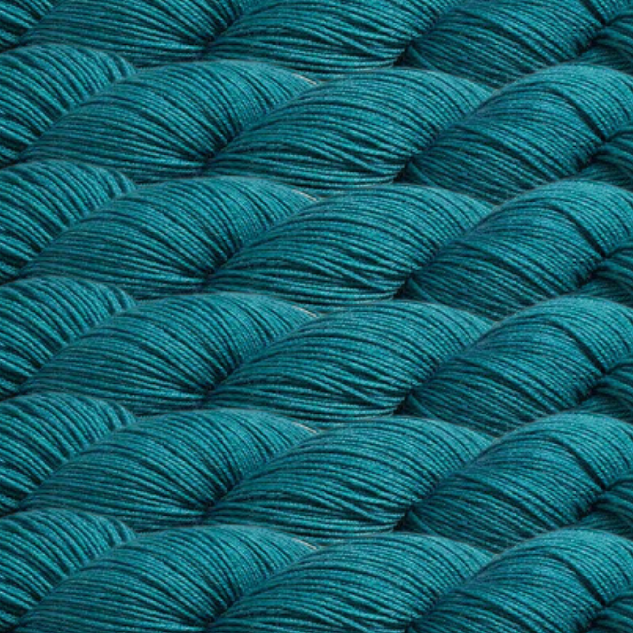 Heritage Yarn in Teal (1045), a rich and vibrant blue-green hue inspired by ocean depths. Crafted from Superwash Merino and Nylon, this fingering-weight yarn offers unparalleled softness, durability, and versatility. Available in 1 lb. cones with 1,996 yards, perfect for weaving, knitting, and crocheting stunning projects.