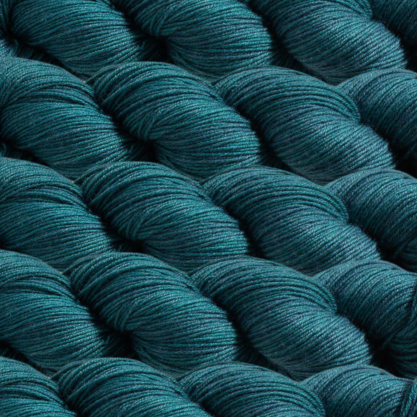 Heritage Yarn in Japanese Indigo (1046), a deep and sophisticated blue-green shade reminiscent of traditional Japanese dye techniques. Made with Superwash Merino and Nylon, this fingering-weight yarn combines softness and strength. Offered in 1 lb. cones with 1,996 yards, perfect for weaving, knitting, and crocheting timeless creations.