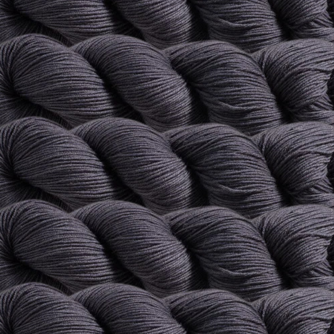 Heritage Yarn in Charcoal Gray, a deep, sophisticated gray perfect for timeless and modern projects alike. Made from a durable blend of Superwash Merino and Nylon, this fingering-weight yarn offers strength and softness. Available in 1 lb. cones with 1,996 yards, ready to inspire your creativity.