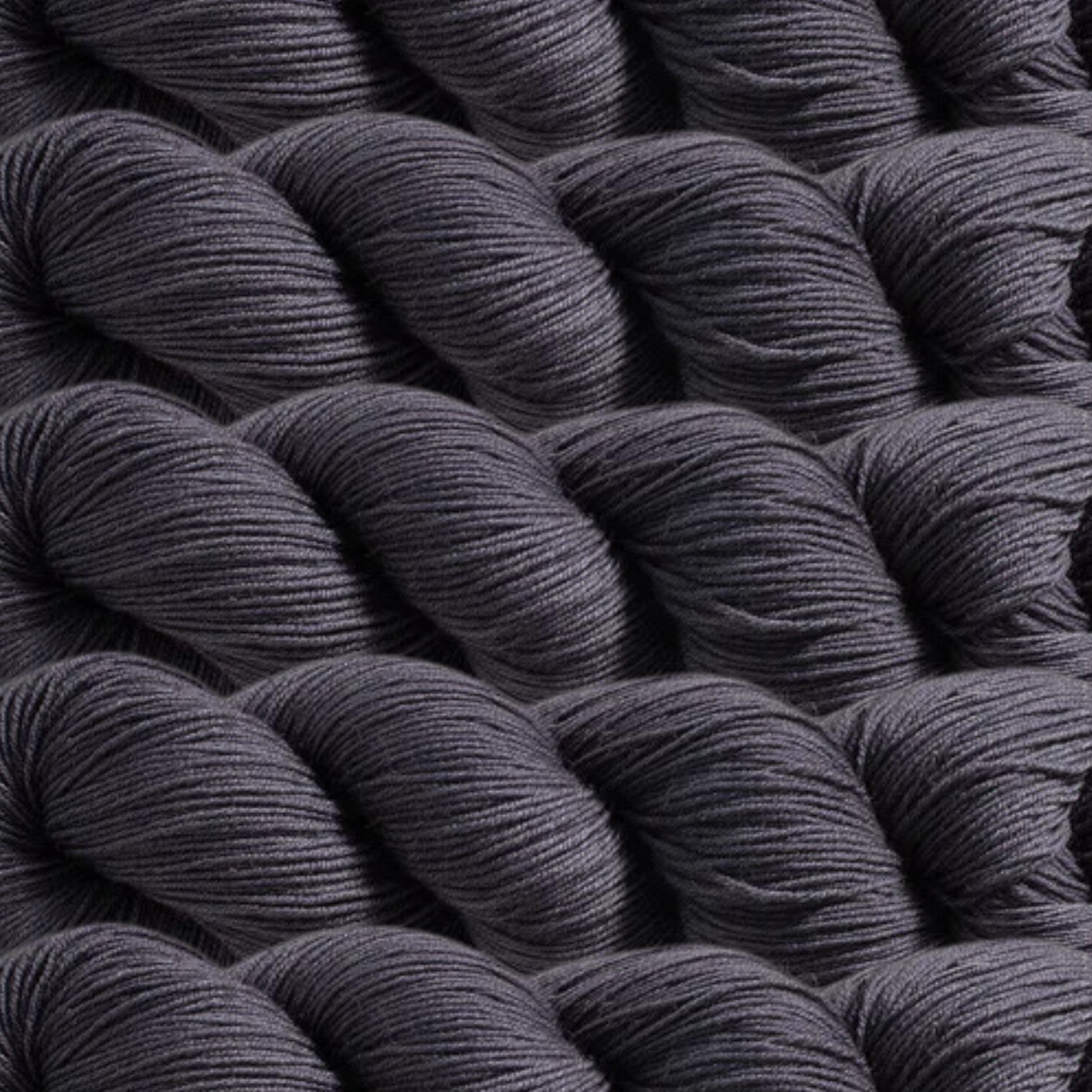 Heritage Yarn in Charcoal Gray, a deep, sophisticated gray perfect for timeless and modern projects alike. Made from a durable blend of Superwash Merino and Nylon, this fingering-weight yarn offers strength and softness. Available in 1 lb. cones with 1,996 yards, ready to inspire your creativity.