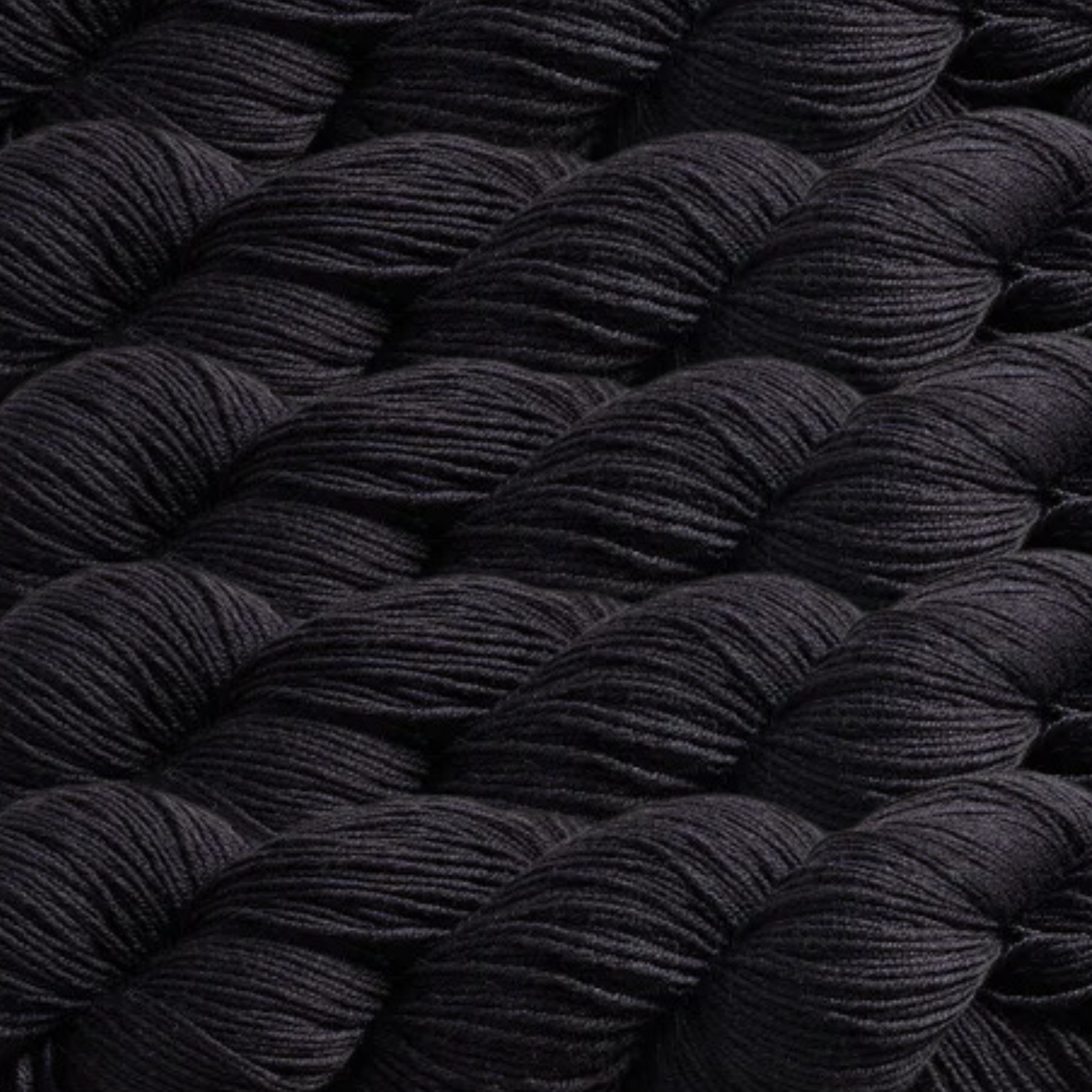 Heritage Yarn in Black, a classic and bold shade perfect for elegant and striking designs. Crafted from a durable Superwash Merino and Nylon blend, this fingering-weight yarn offers softness and strength. Available in 1 lb. cones with 1,996 yards, ideal for knitting, crocheting, and weaving projects.