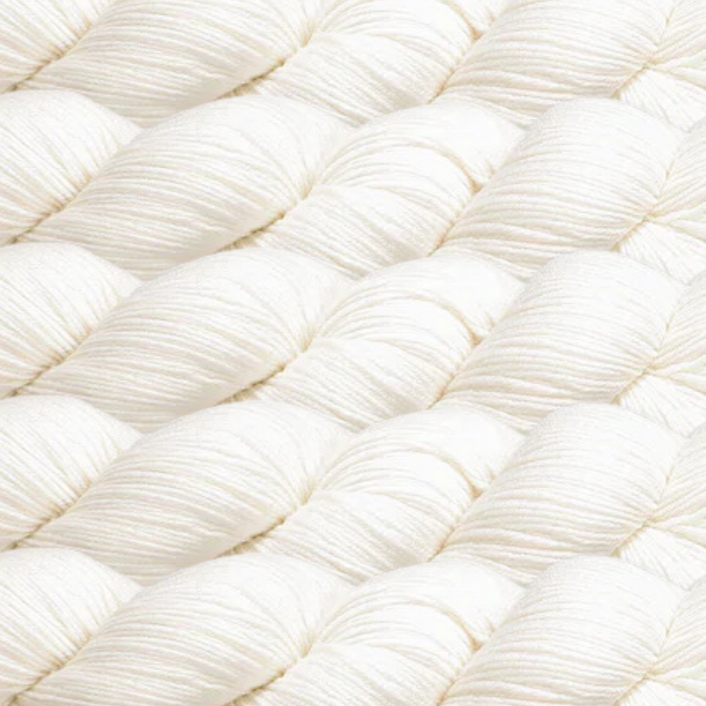 Heritage Yarn in Soft White, a pure and timeless shade perfect for clean, elegant designs. This versatile fingering-weight yarn is crafted from a Superwash Merino and Nylon blend, offering exceptional softness and durability. Available in 1 lb. cones with 1,996 yards, ideal for knitting, crocheting, and weaving projects.