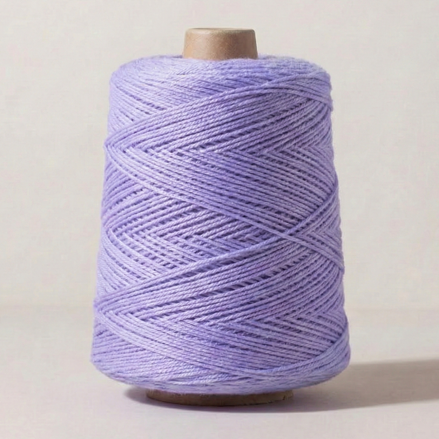 Heritage Yarn in Light Periwinkle (1006), a soft lavender shade with subtle blue undertones. This Superwash Merino and Nylon worsted-weight yarn is perfect for weaving, knitting, and crocheting projects. Offered in 1 lb. cones with 1,000 yards, providing exceptional versatility and creative potential.