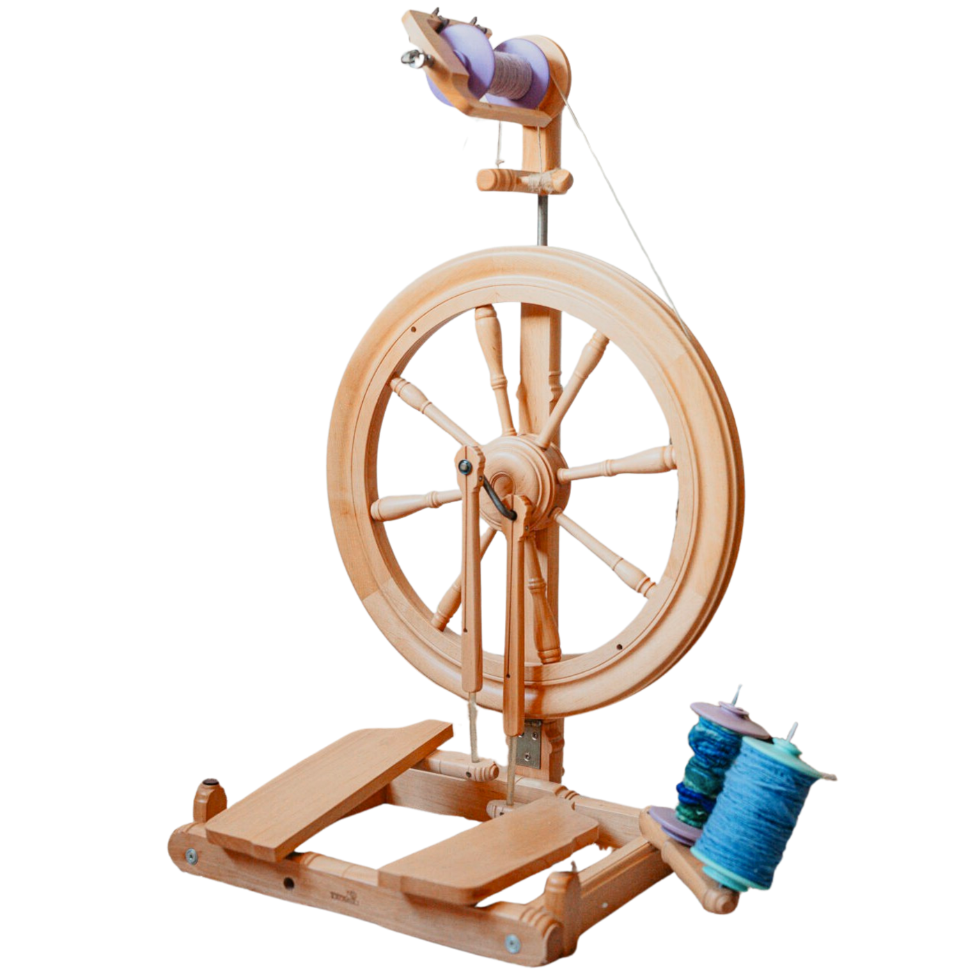 Kromski Sonata Encore spinning wheel on white background with blue yarn bobbin—castle-style wheel built for portable spinning.