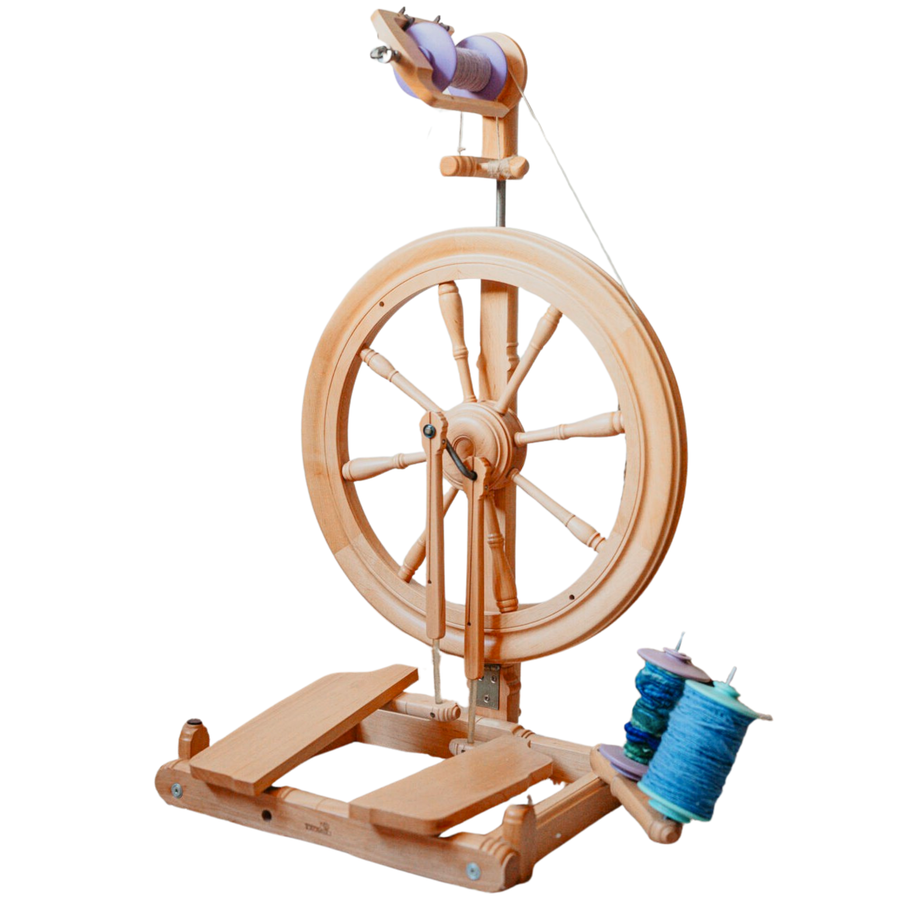 Kromski Sonata Encore spinning wheel on white background with blue yarn bobbin—castle-style wheel built for portable spinning.