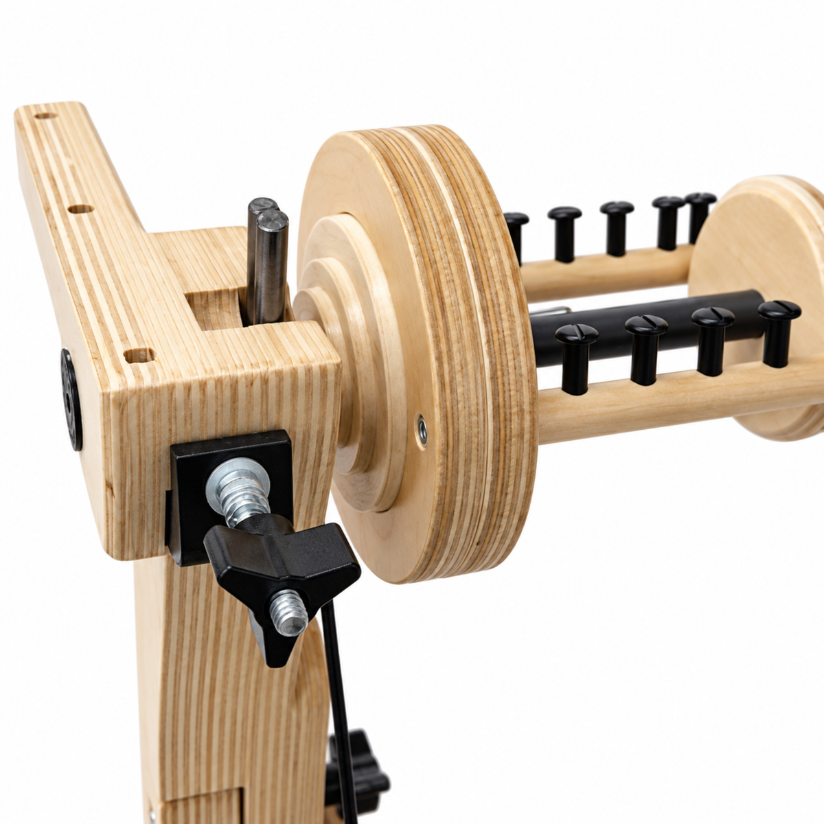 Close-up of the SpinOlution Pollywog spinning wheel flyer and wooden bobbin, showing the orifice assembly and adjustable tension hardware.
