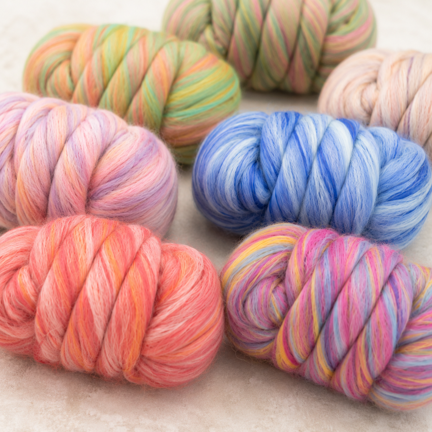 Close-up of colorful Bambino Merino wool and bamboo combed top bundles showing the smooth blended fiber texture