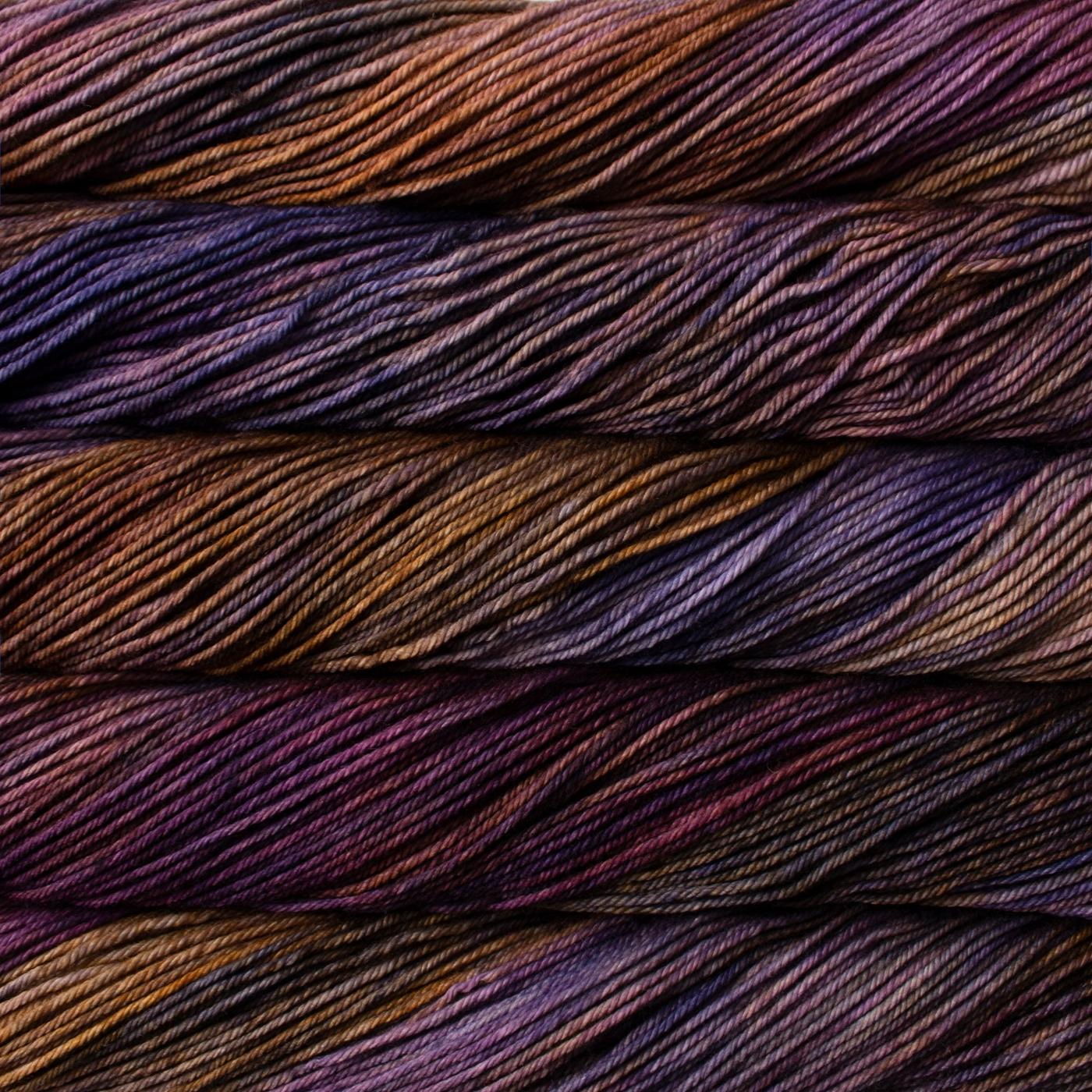 Malabrigo Rios hand-dyed worsted yarn in Aquarius RIO288, blending deep plum, brown, violet, and muted blue.