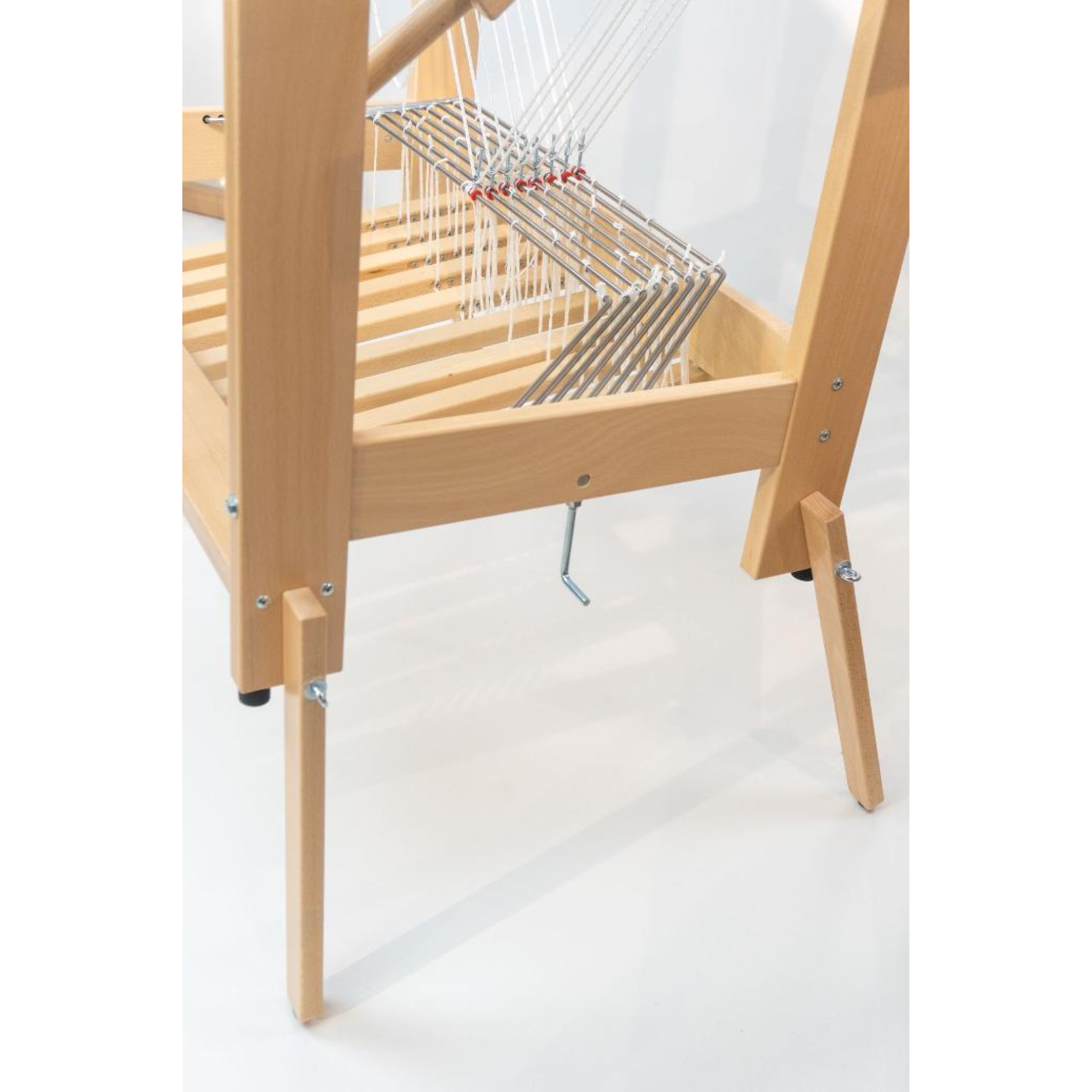 Detail of the loom’s leg and frame joinery, illustrating sturdy beech construction and floor protectors.