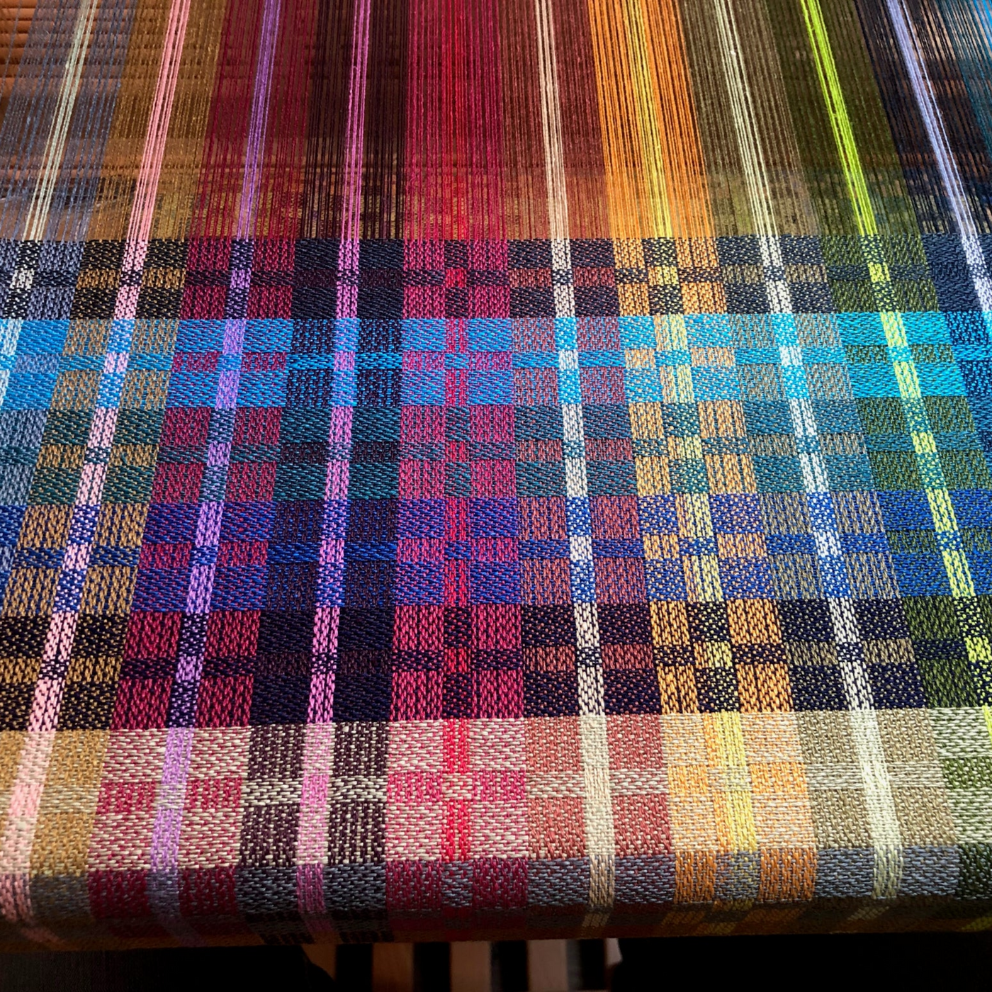 Woven sample of Euroflax 14/4 Linen Yarn showcasing full color range in a plaid pattern. Ideal for visualizing color combinations and sett options in weaving projects using 100% long-line Belgian flax yarn.