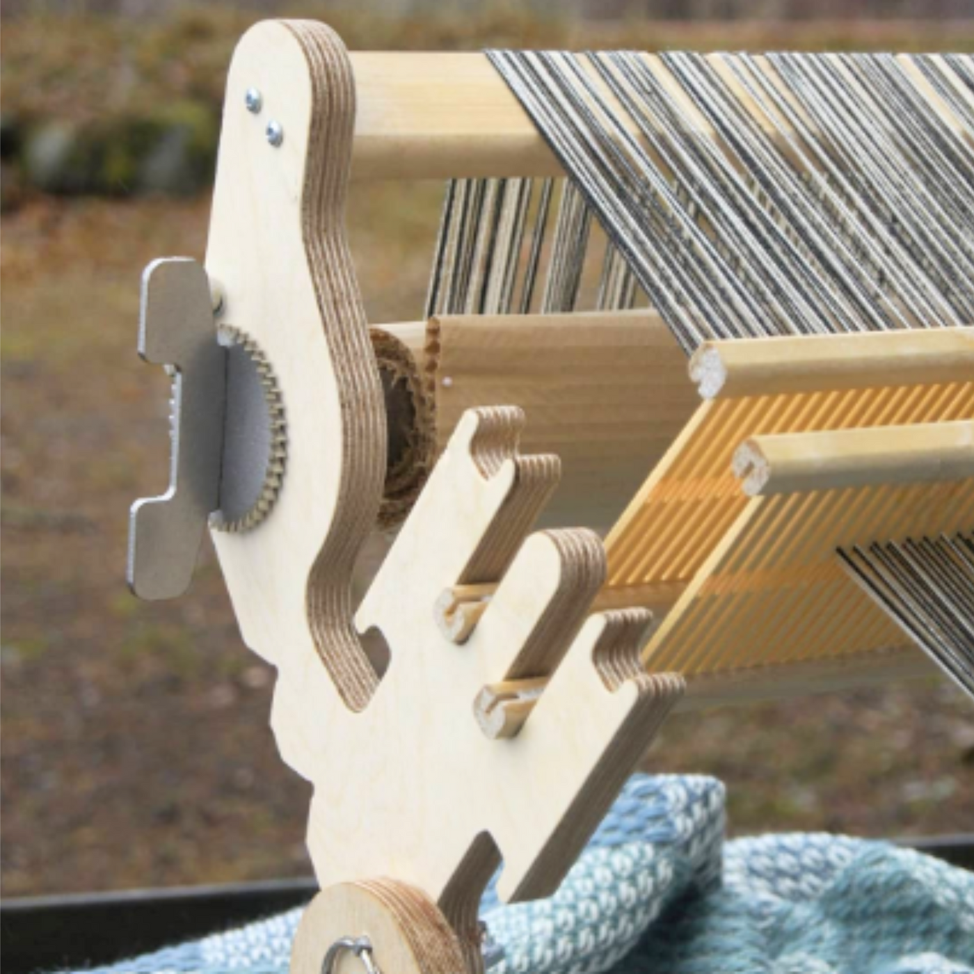 Close-up view of the Glimakra Siru Rigid Heddle Loom highlighting its built-in double heddle brackets and sturdy construction. The ergonomic design and high-quality stainless steel ratchets ensure smooth, precise weaving for both single and double heddle techniques.