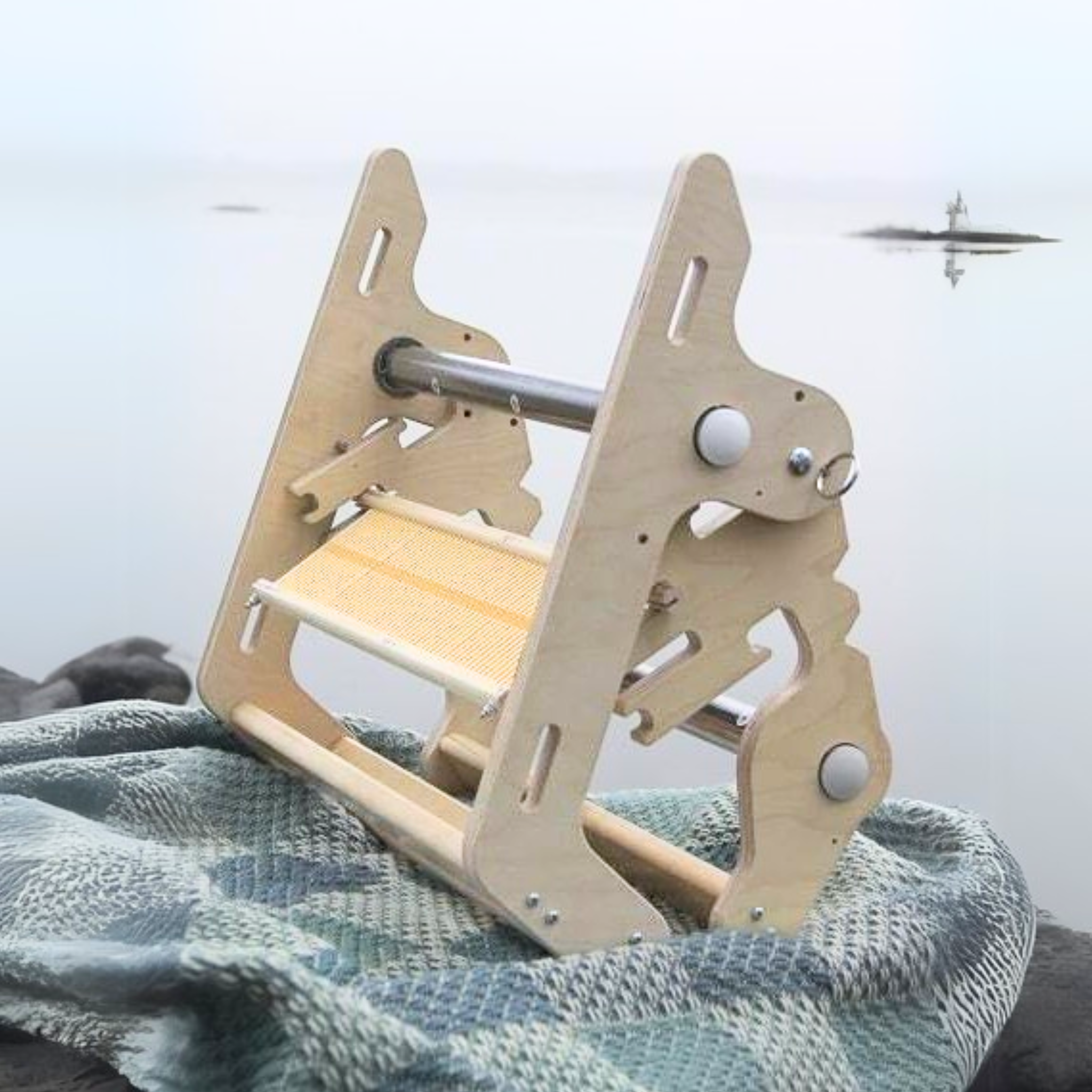 Glimakra Siru Rigid Heddle Loom in its folded position, showcasing its compact and travel-friendly design. This Swedish-made loom is perfect for portable weaving, featuring an ergonomic build and durable stainless steel components for smooth and precise weaving anywhere.