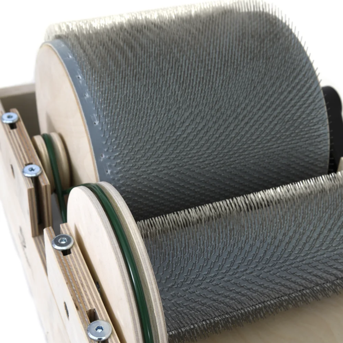 Close-up of the Golden Fleece drum carder showing the steel carding cloth on the main drum and licker-in.
