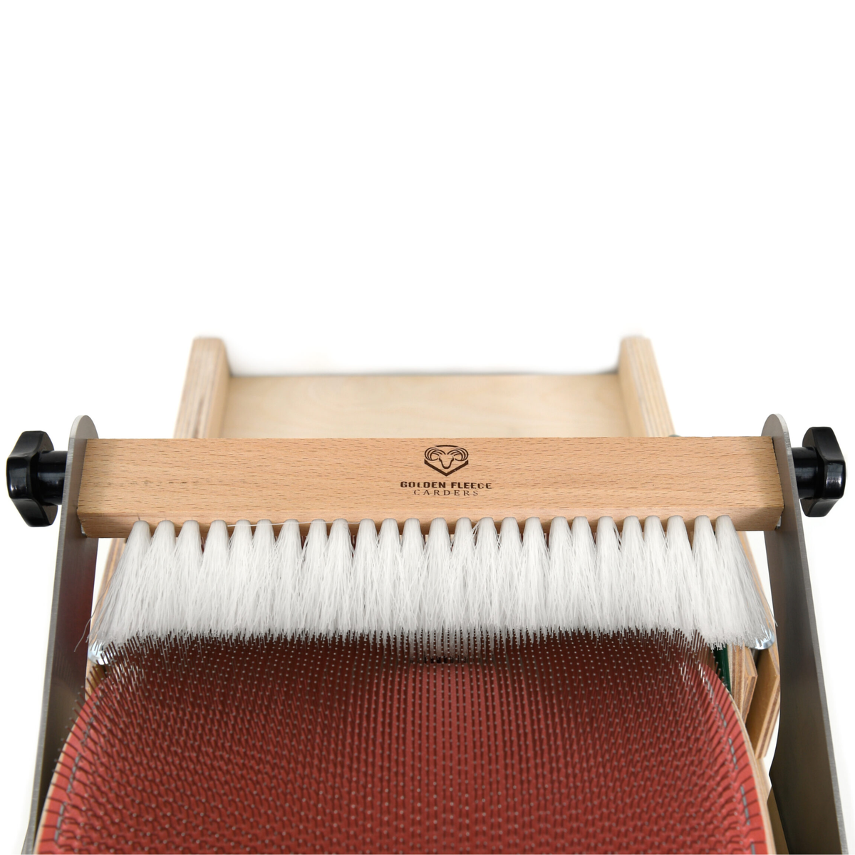 Golden Fleece Packer Brush positioned over the drum carder while fiber is being packed onto the main drum.