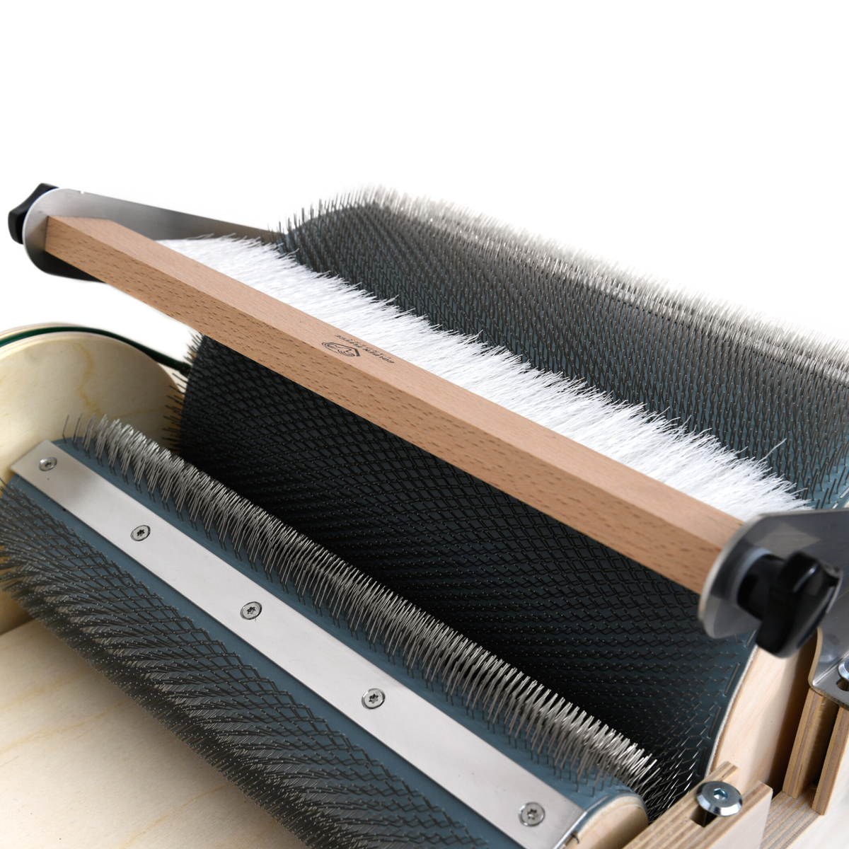 Close-up of the Golden Fleece Packer Brush mounted above the standard drum carder's main drum.