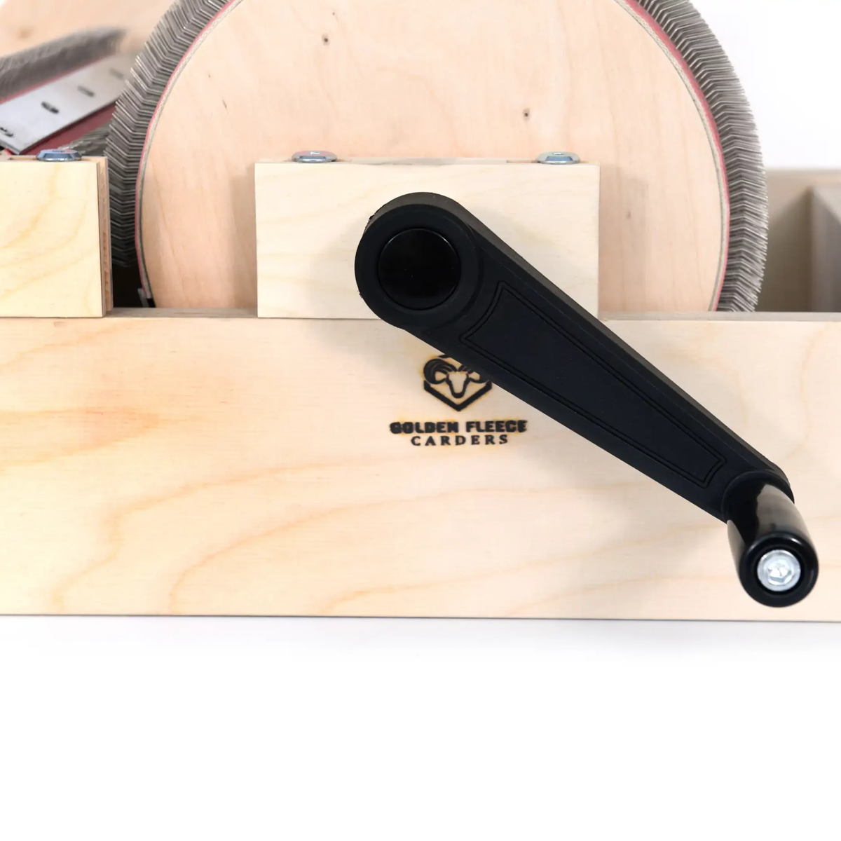 Close-up of the Golden Fleece WIDE 120 TPI drum carder's hand crank, wooden drum end, and fine carding cloth.