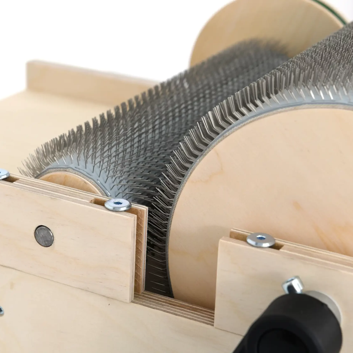 Side detail of the Golden Fleece WIDE 54 TPI drum carder showing the coarse carding cloth, wooden drum end, and frame.