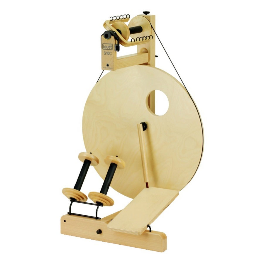 Front view of Louet S10 Single Treadle Spinning Wheel with included bobbins on lazy kate, showcasing the classic Irish tension system and large drive wheel.