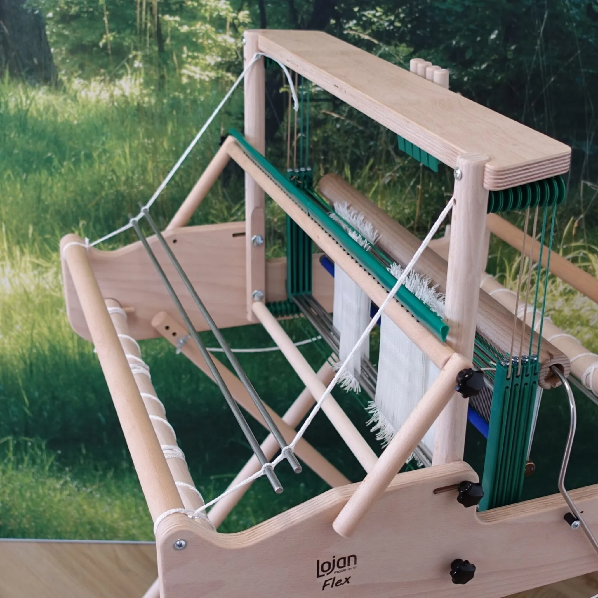 Three-quarter rear view of Lojan Raddle Flex in use on a Lojan Flex loom, demonstrating precise warp spacing and tidy path to the beam.