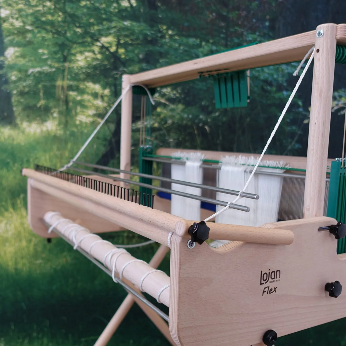 Side view of the Lojan Raddle Flex on a Lojan Flex loom during back-to-front warping, guiding strands at the correct weaving width.