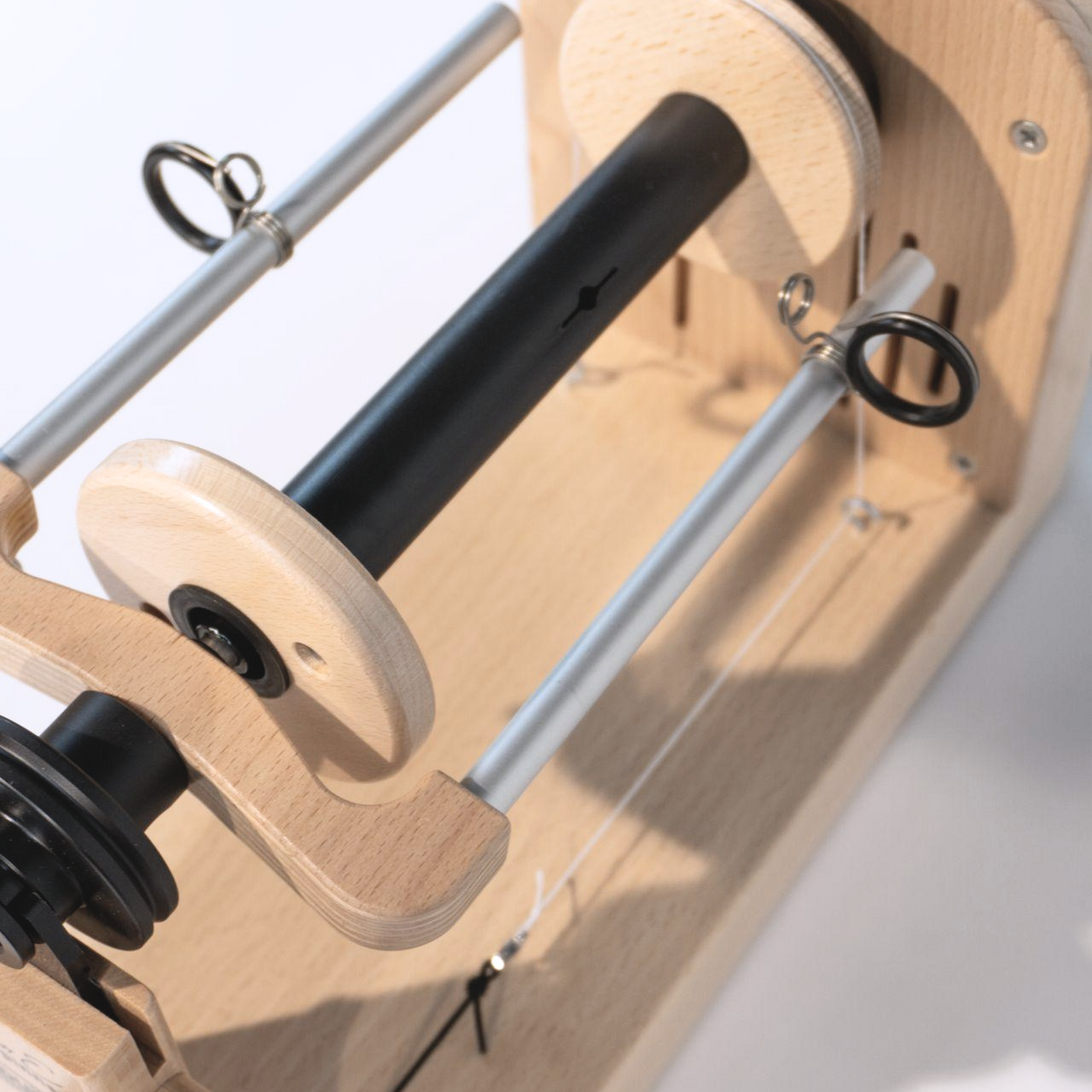 Close-up view of the bobbin and flyer assembly on the Louet Jenn-E Electric Spinning Wheel, highlighting the smooth operation and durable construction.