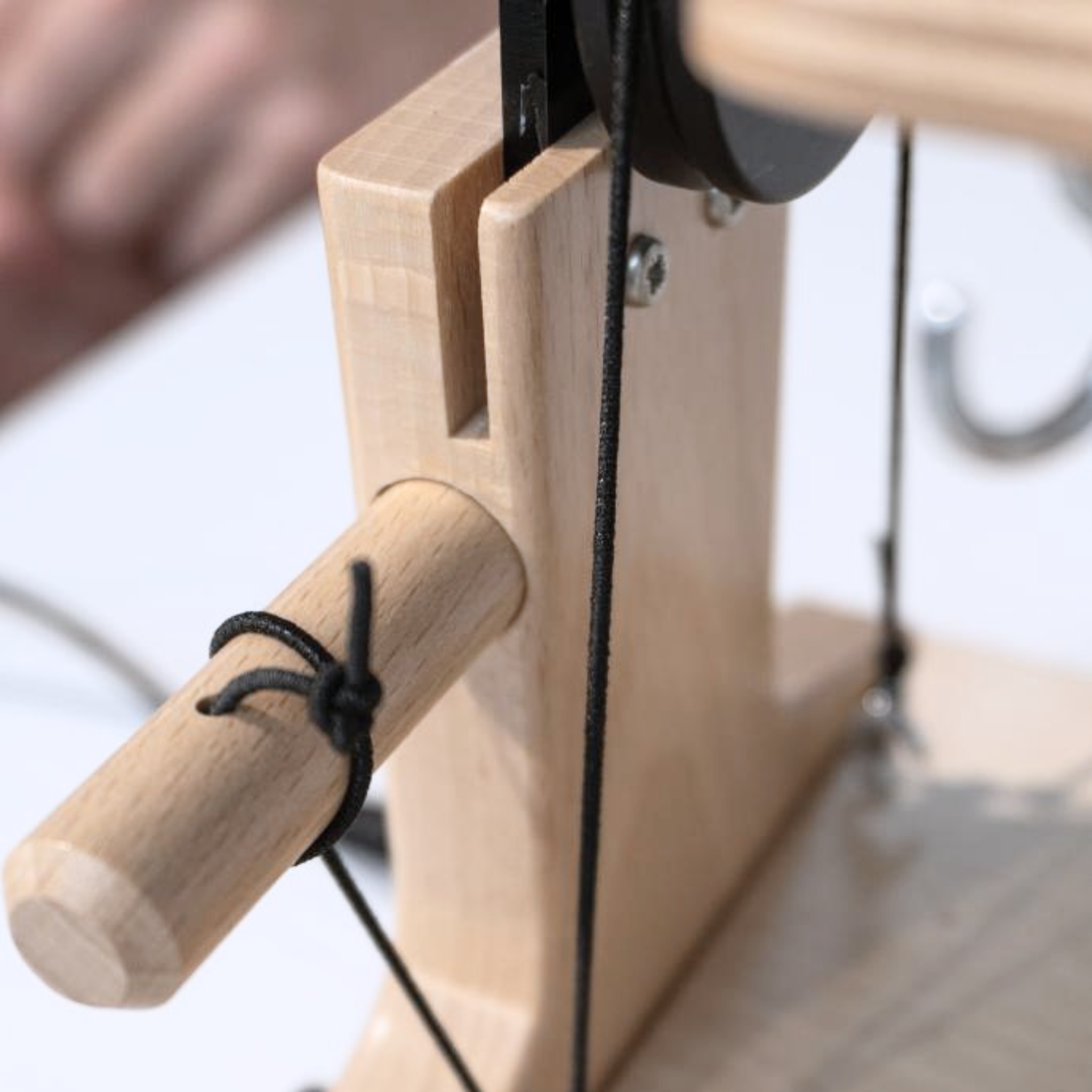 Close-up of the tension knob on the Louet Jenn-E Electric Spinning Wheel, highlighting the precise tension control for Scotch and Irish tension setups.