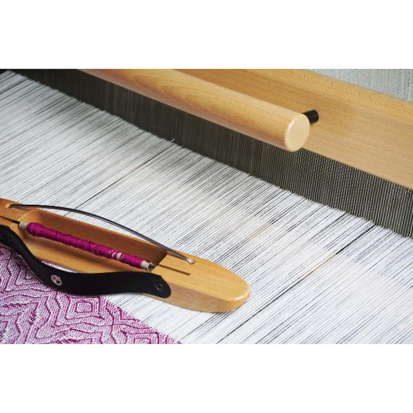 Close‑up of Spring II beater and cloth advance showing smooth shuttle race and texsolv cords