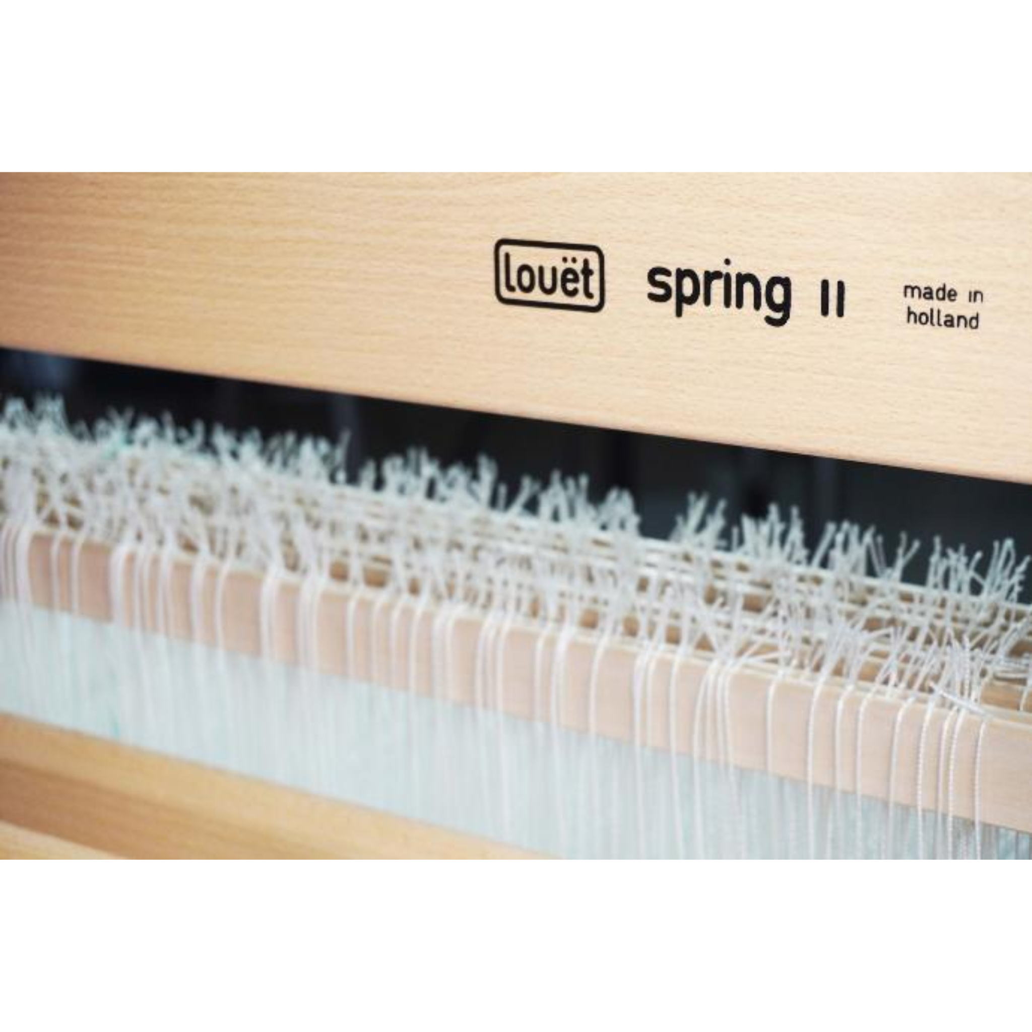 Louët Spring II engraved logo on castle, illustrating solid beech construction and lacquer finish