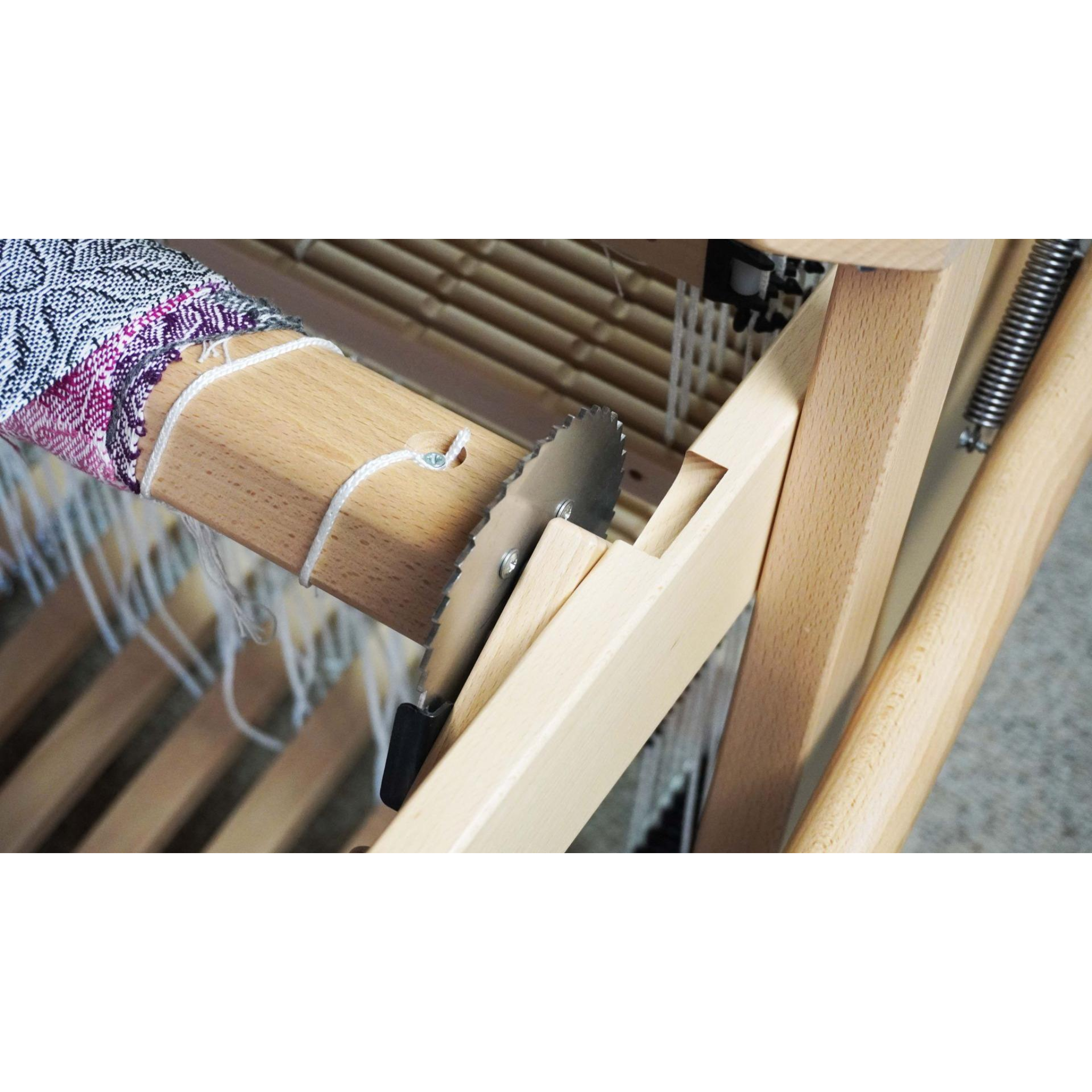 Shuttle passing through open shed on Spring II loom, showing stainless reed and texsolv heddles