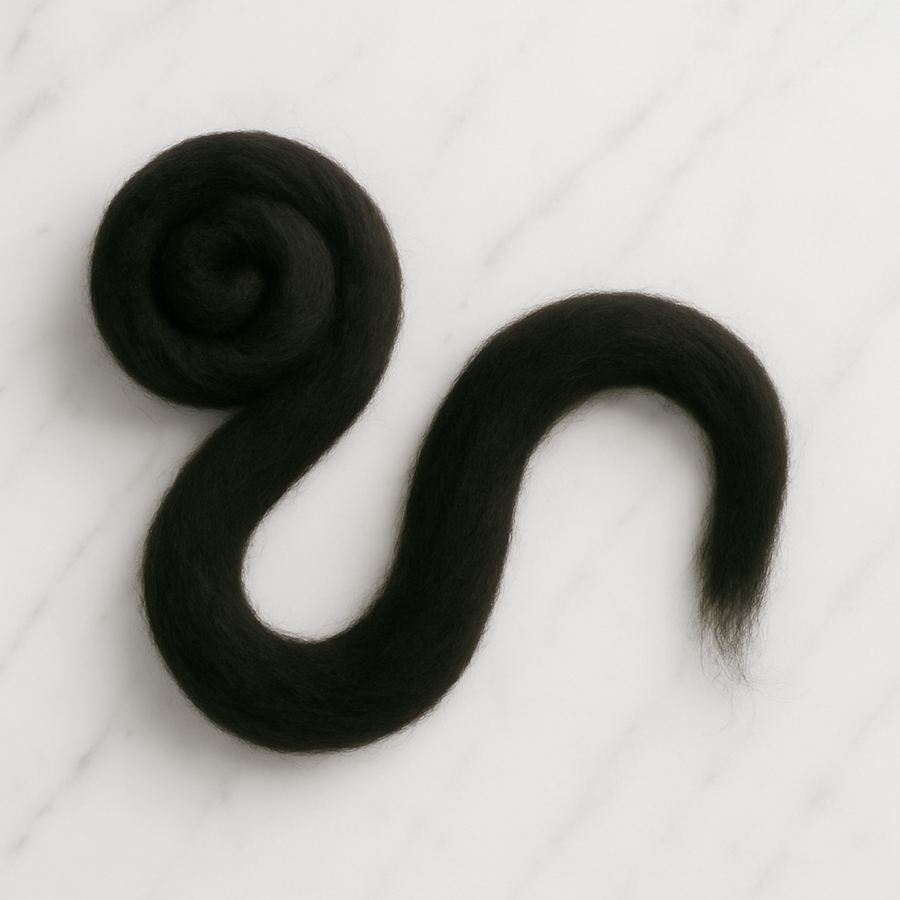 19 Micron Black Carded Merino Wool Sliver – Unraveled Strand on White Marble Background