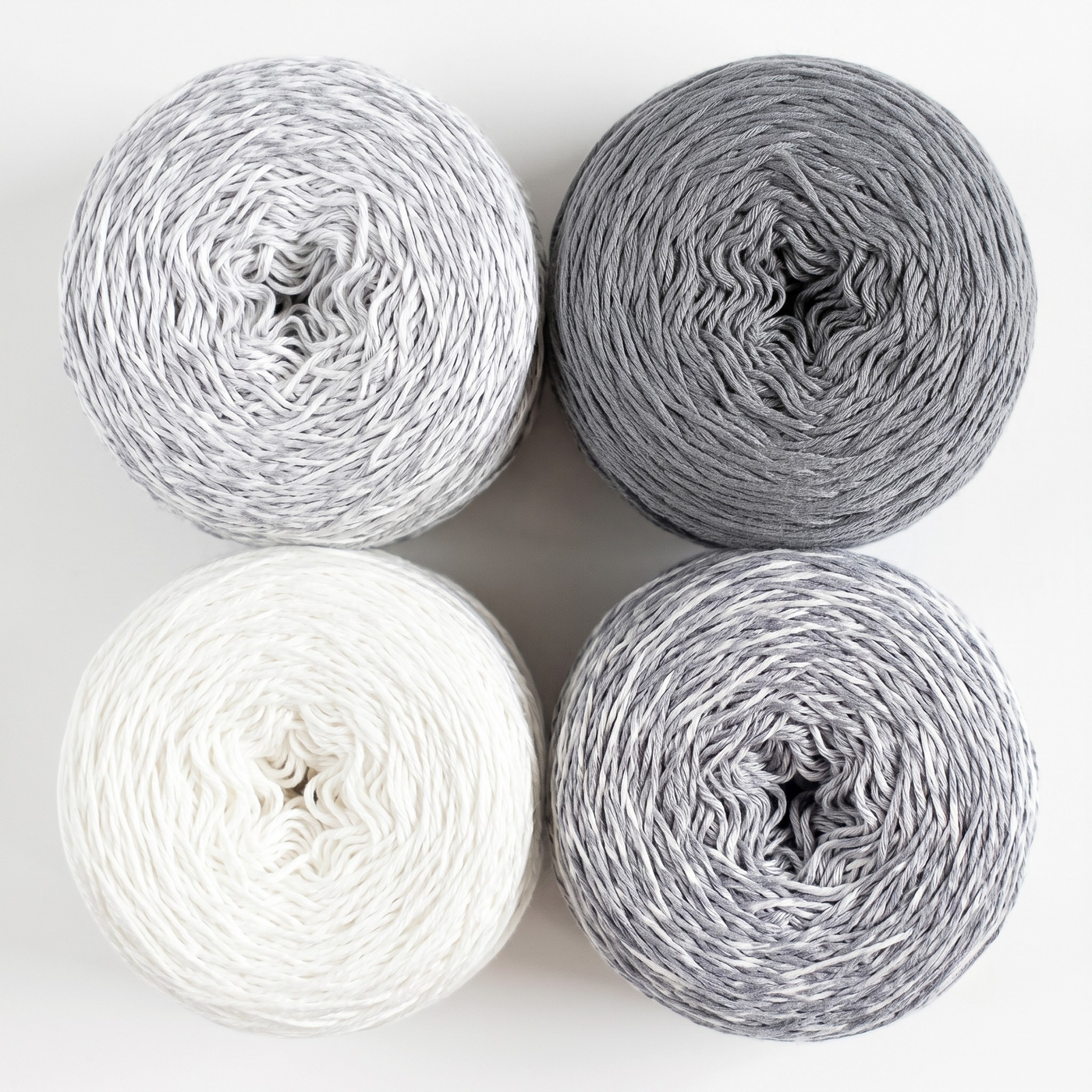 Revolution Fibers Baby Bloom Gradient Baby Blanket Kit Helios Gray yarn cakes shown from above in a 2x2 grid.