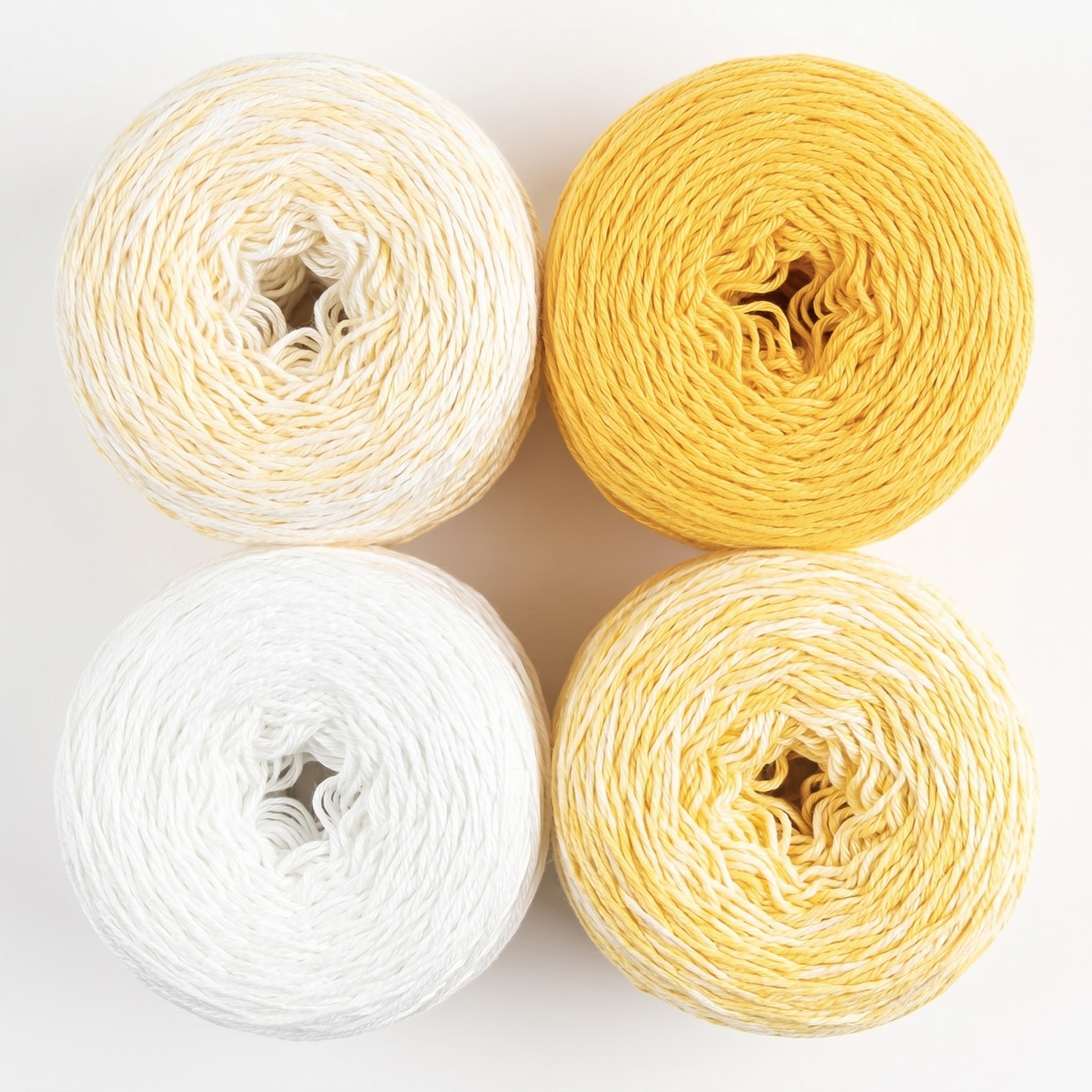 Revolution Fibers Baby Bloom Gradient Baby Blanket Kit Honey Bees yarn cakes shown from above in a 2x2 grid.