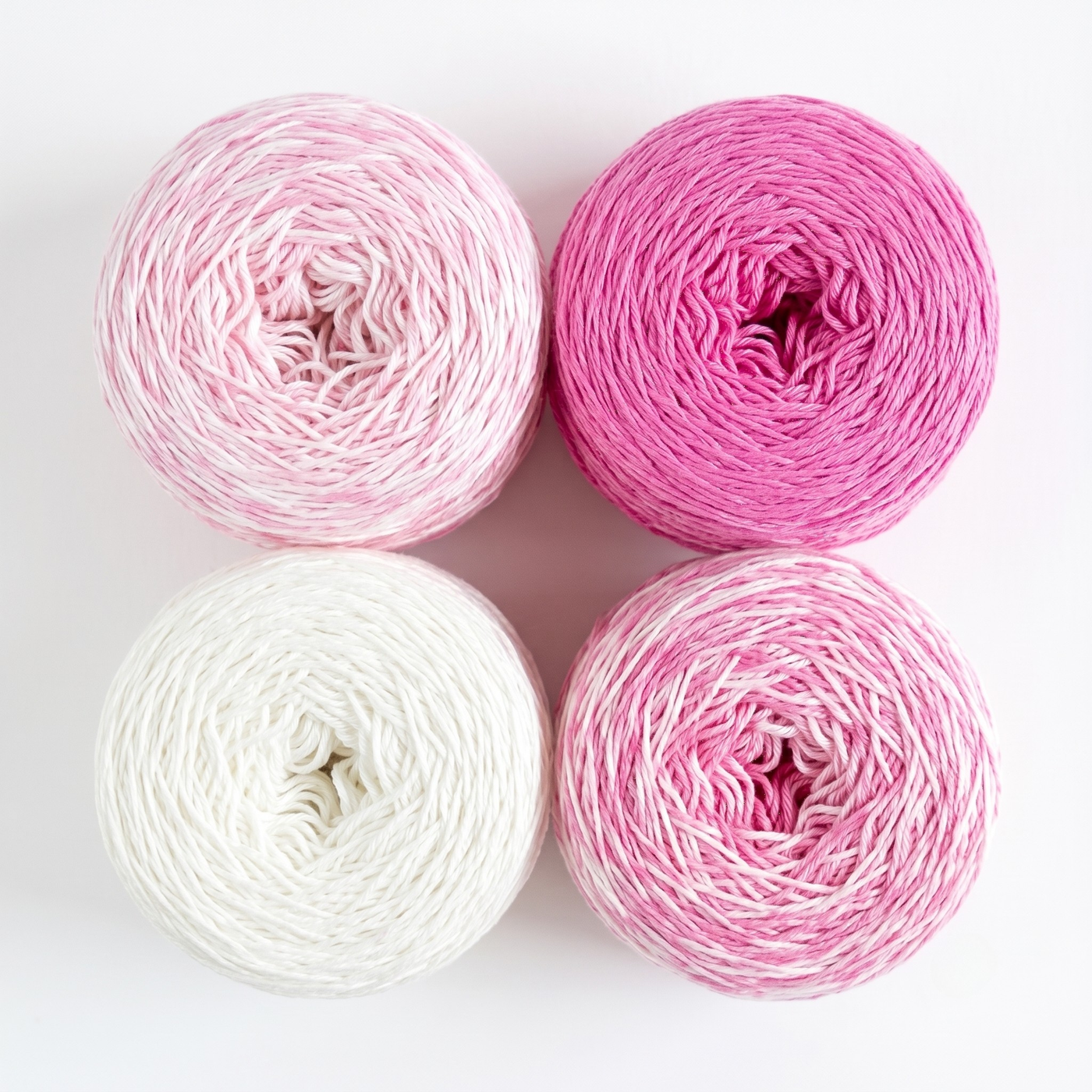 Revolution Fibers Baby Bloom Gradient Baby Blanket Kit Pink Flamingo yarn cakes shown from above in a 2x2 grid.