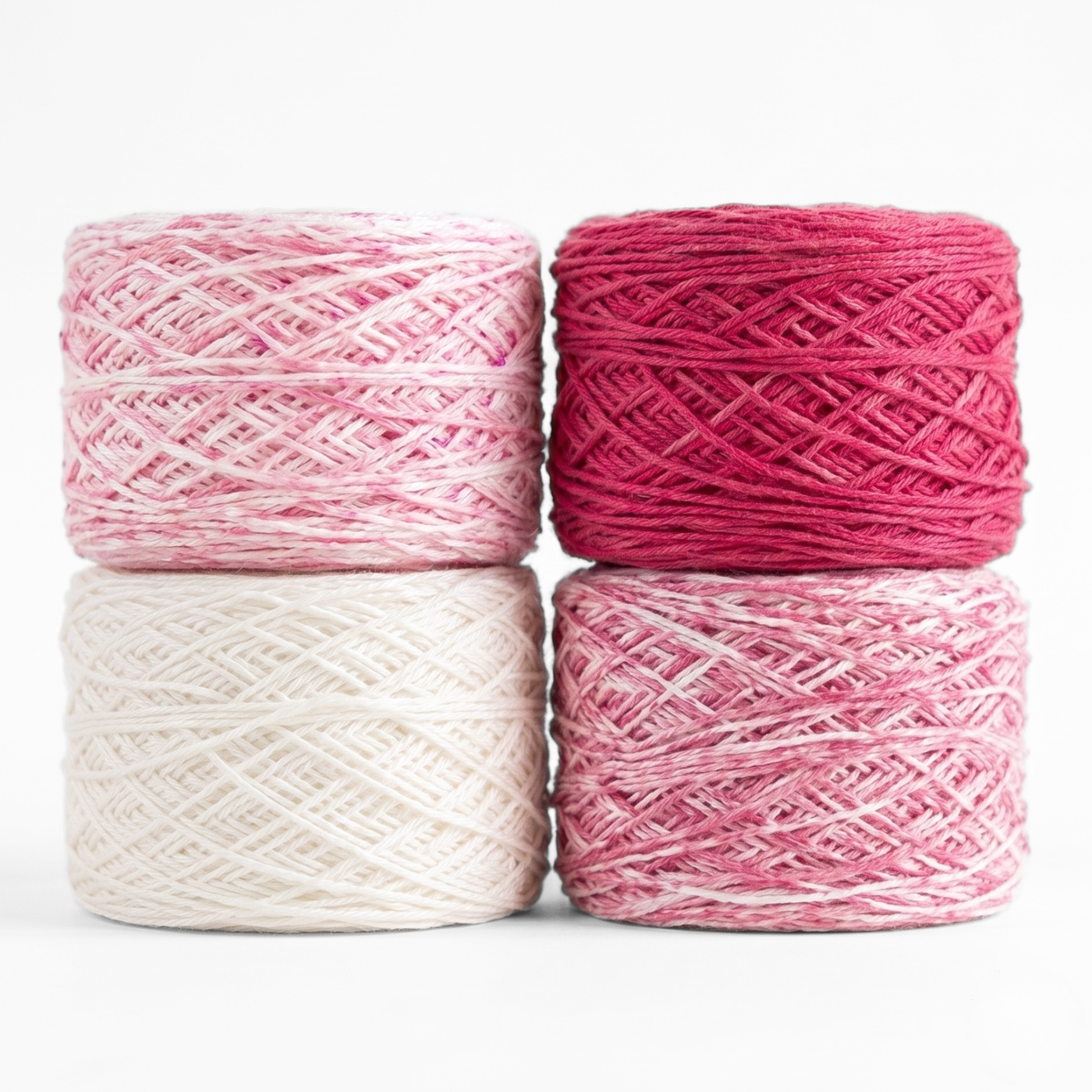 Revolution Fibers Baby Bloom Gradient Baby Blanket Kit Rose Dust yarn cakes in white, speckled pink, and solid rose.