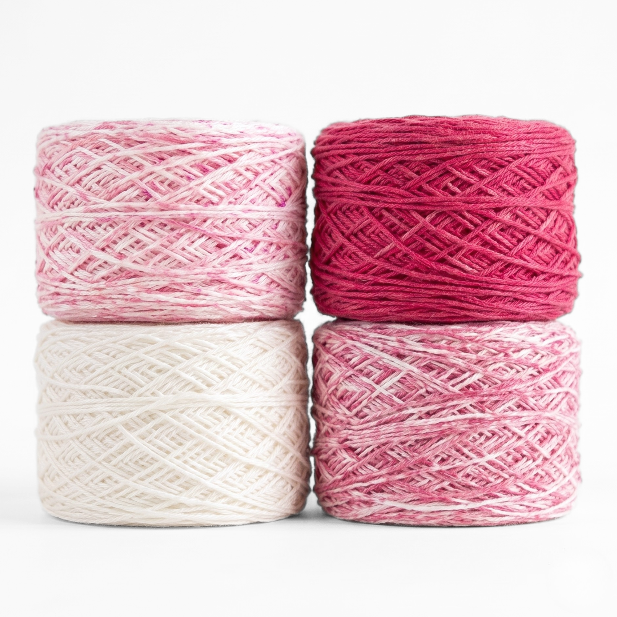 Revolution Fibers Baby Bloom Gradient Baby Blanket Kit Rose Dust yarn cakes in white, speckled pink, and solid rose.