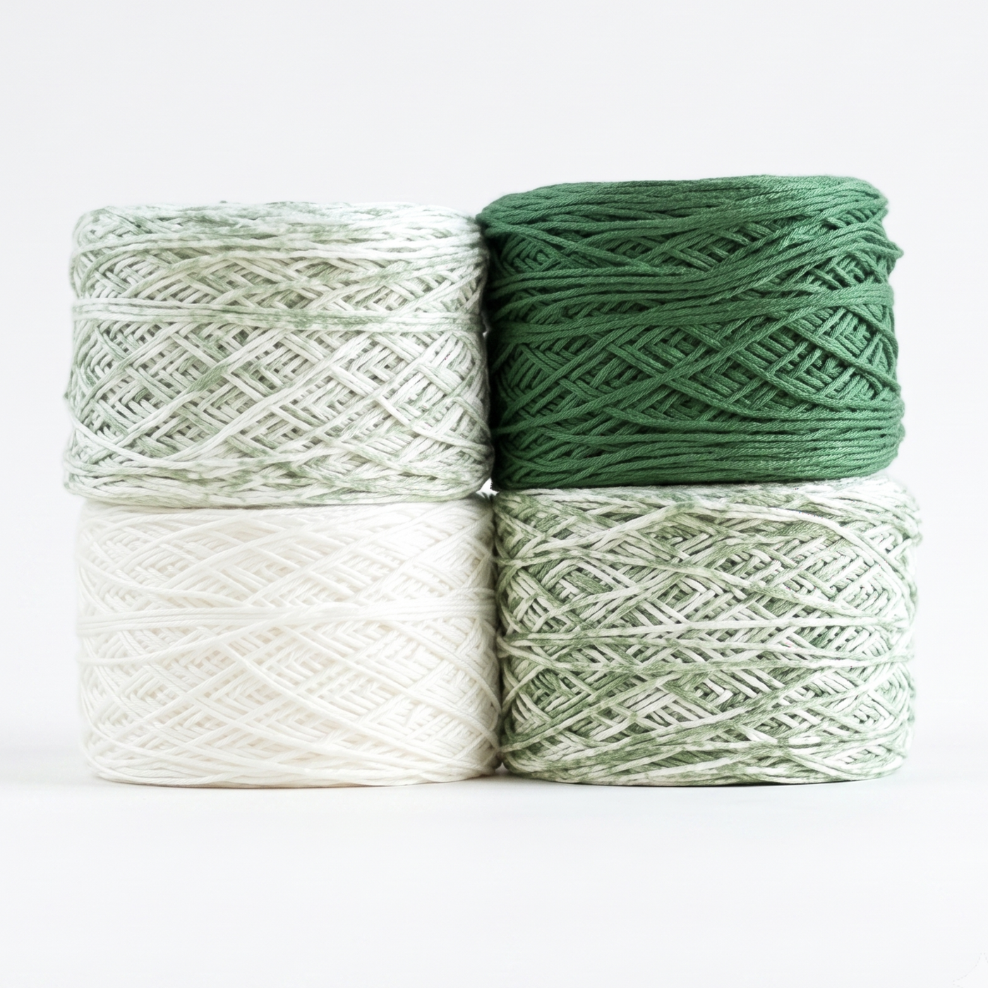 Revolution Fibers Baby Bloom Gradient Baby Blanket Kit Spring Leaf yarn cakes in white, green speckle, and solid green.