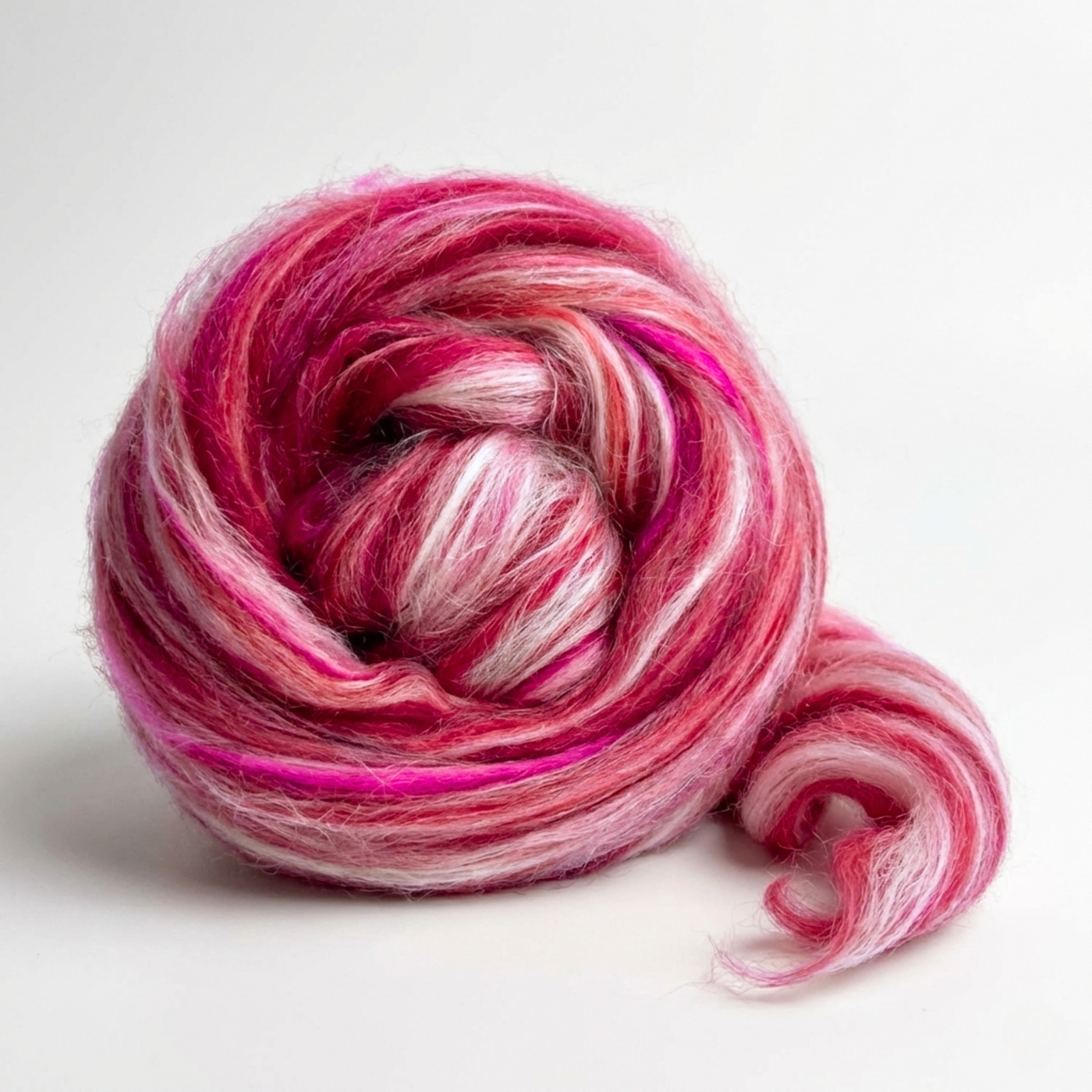 Aries Pink Constellation Range roving, 8 oz 70% dyed merino and 30% tussah silk (21 micron), studio swirl on white background.