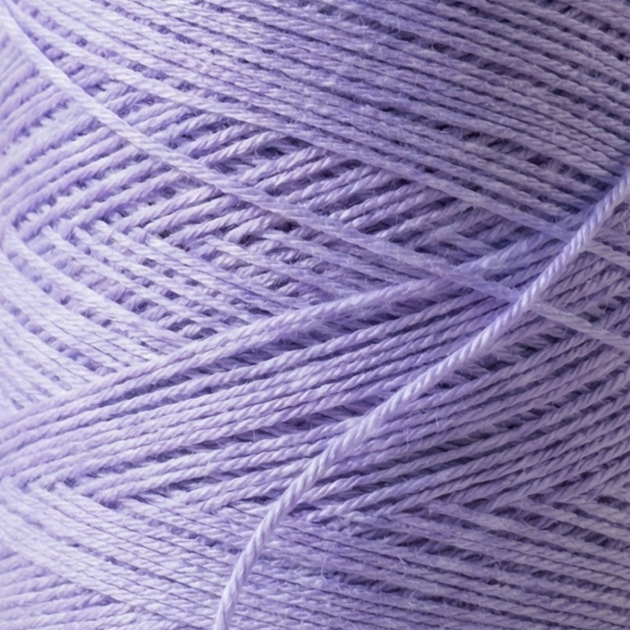 Close-up macro photo of Heritage worsted cone yarn showing winding texture and strand detail for stitch definition and weaving performance.