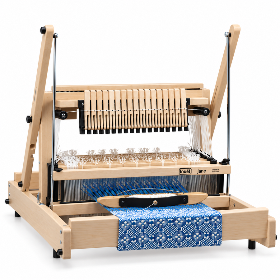 Louet jane multi shaft loom with a blue intricately patterned cloth.