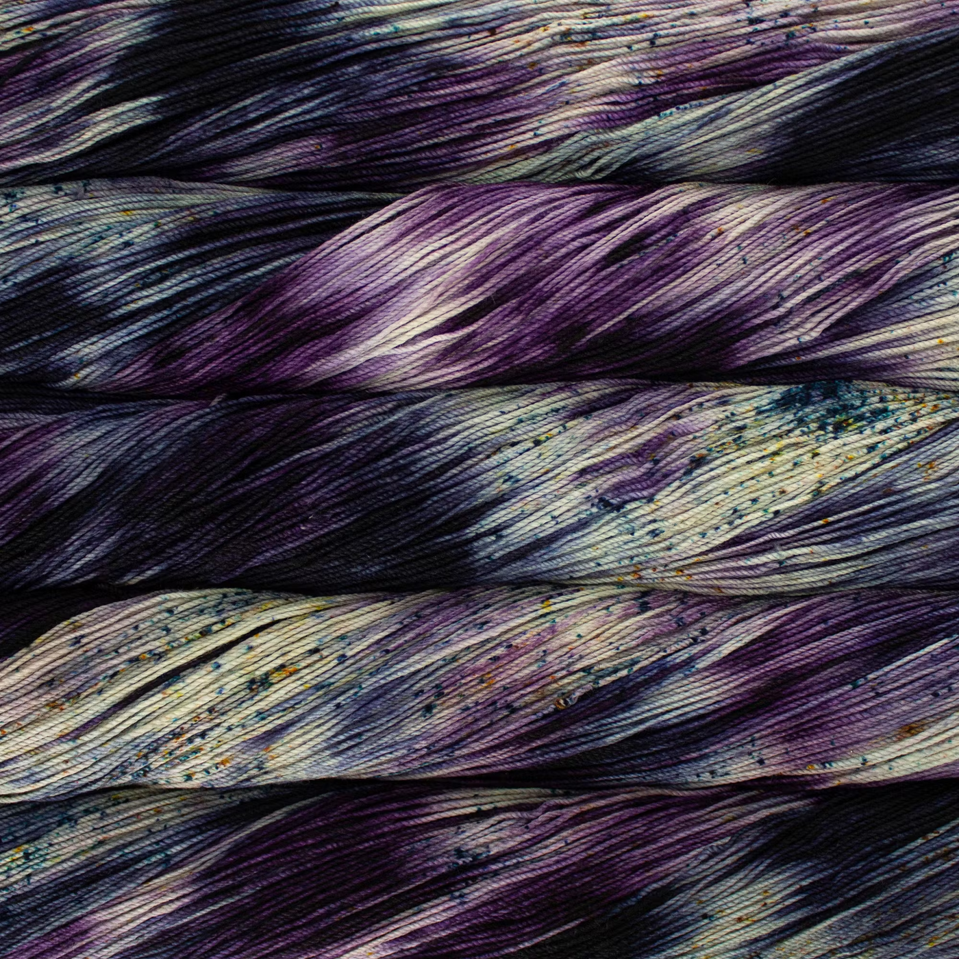 Malabrigo Sock Yarn Ursula SW365 – An inky purple and deep teals with flecks of gold fingering superwash Merino wool from Revolution Fibers.
