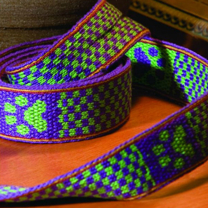 A colorful patterned pet leash woven on a tablet inkle loom.